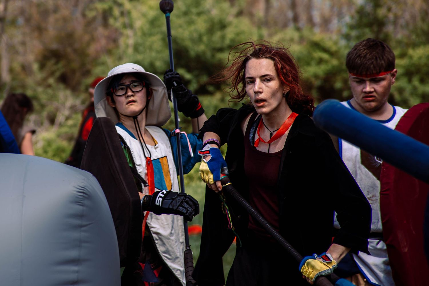 A group of people gather outdoors in casual attire during what appears to be a social event or gathering.