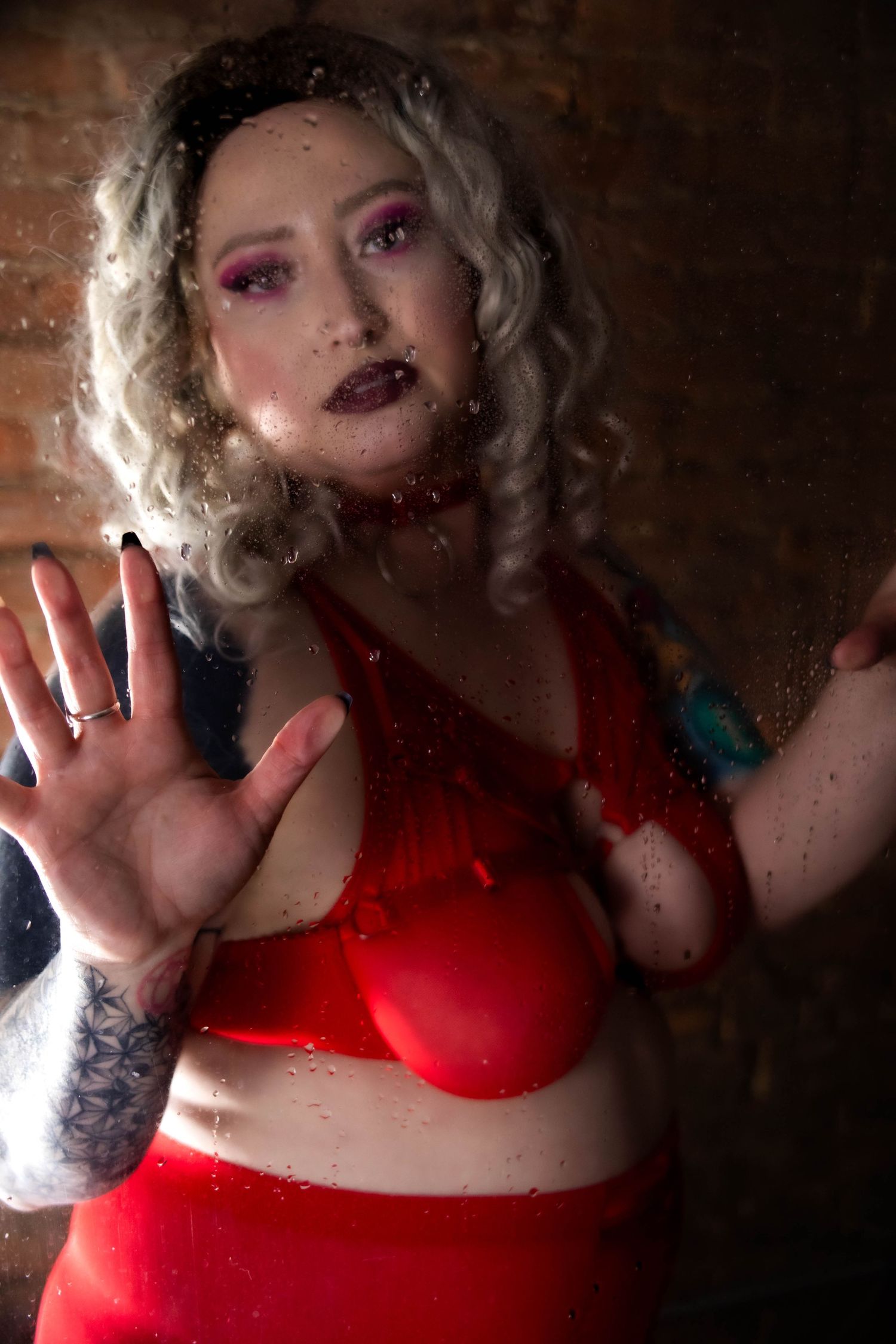 Artistic photo series showing dramatic poses in a red top against a dark textured background with moody lighting.