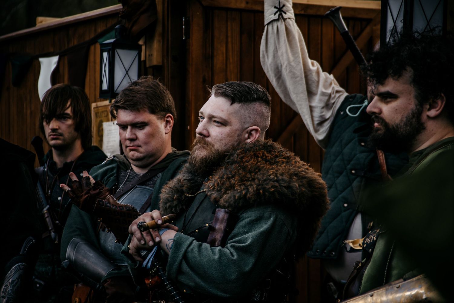 Group of men dressed in medieval Viking costumes at a historical reenactment event.