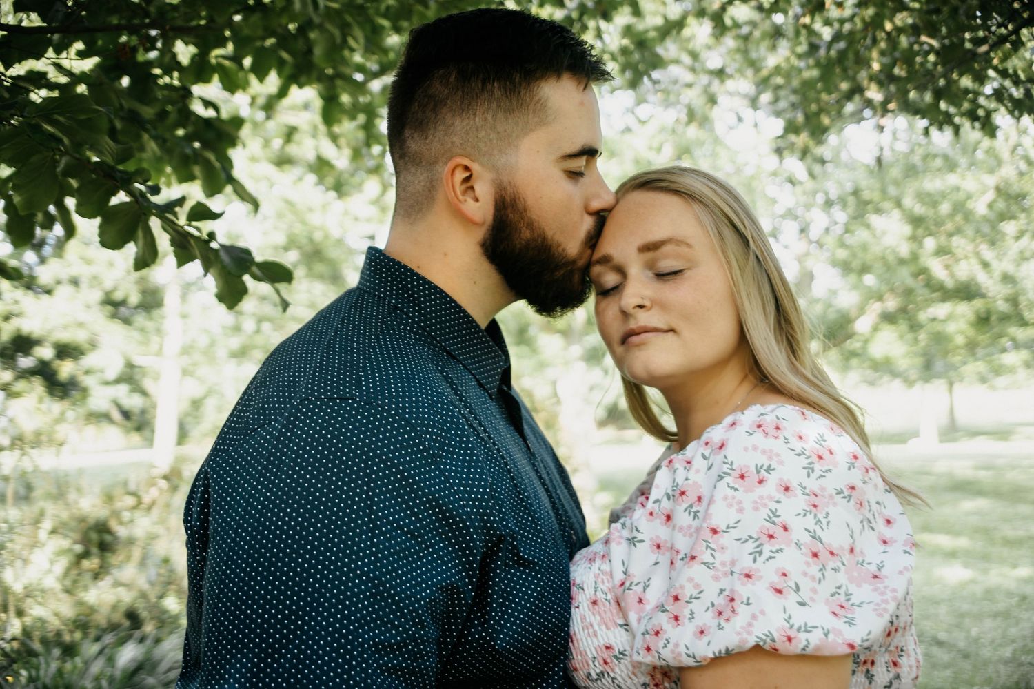 Romantic outdoor couple photography session in a lush green garden setting.