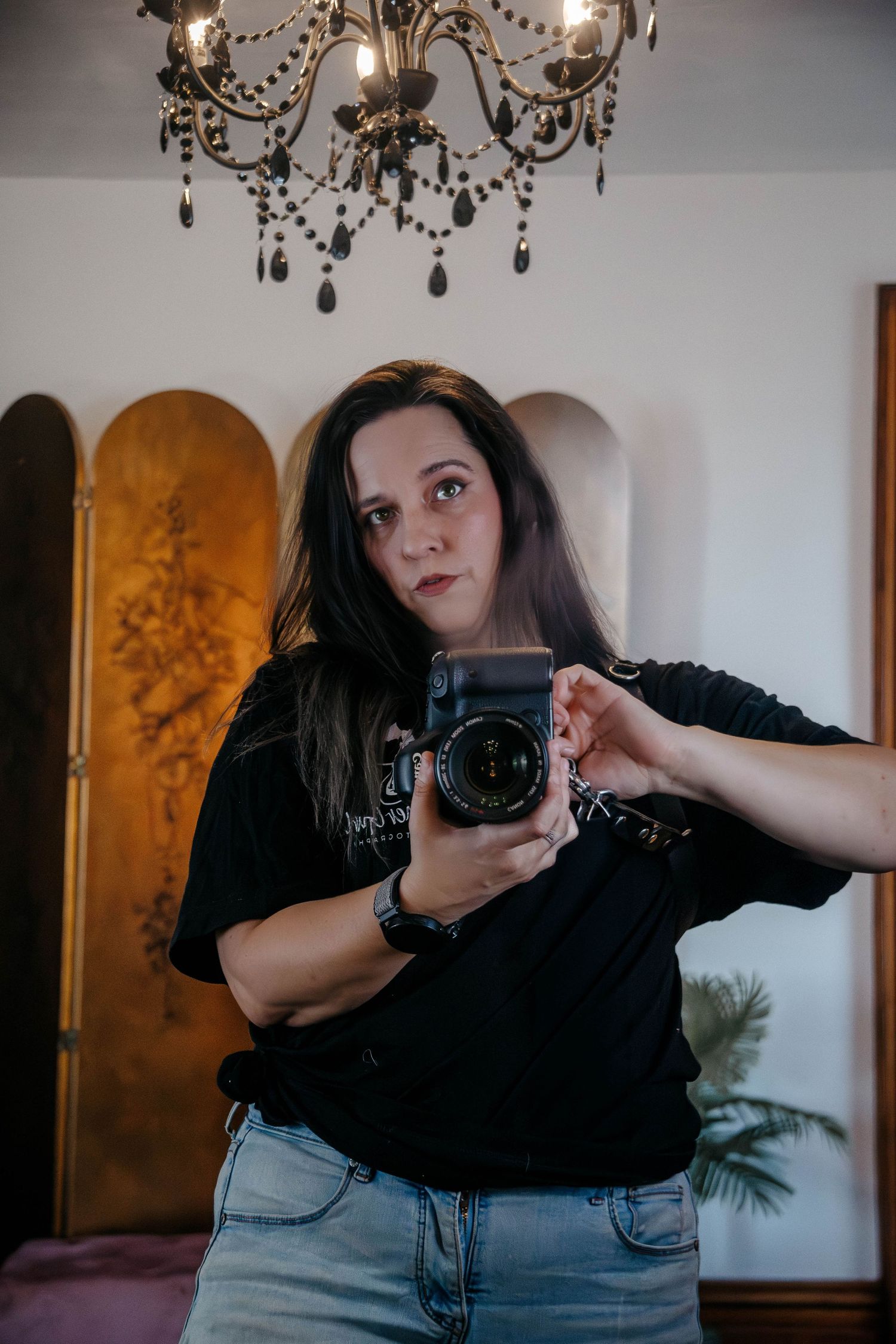 A series of photos showing a person in a black shirt taking photos with a camera under a crystal chandelier.