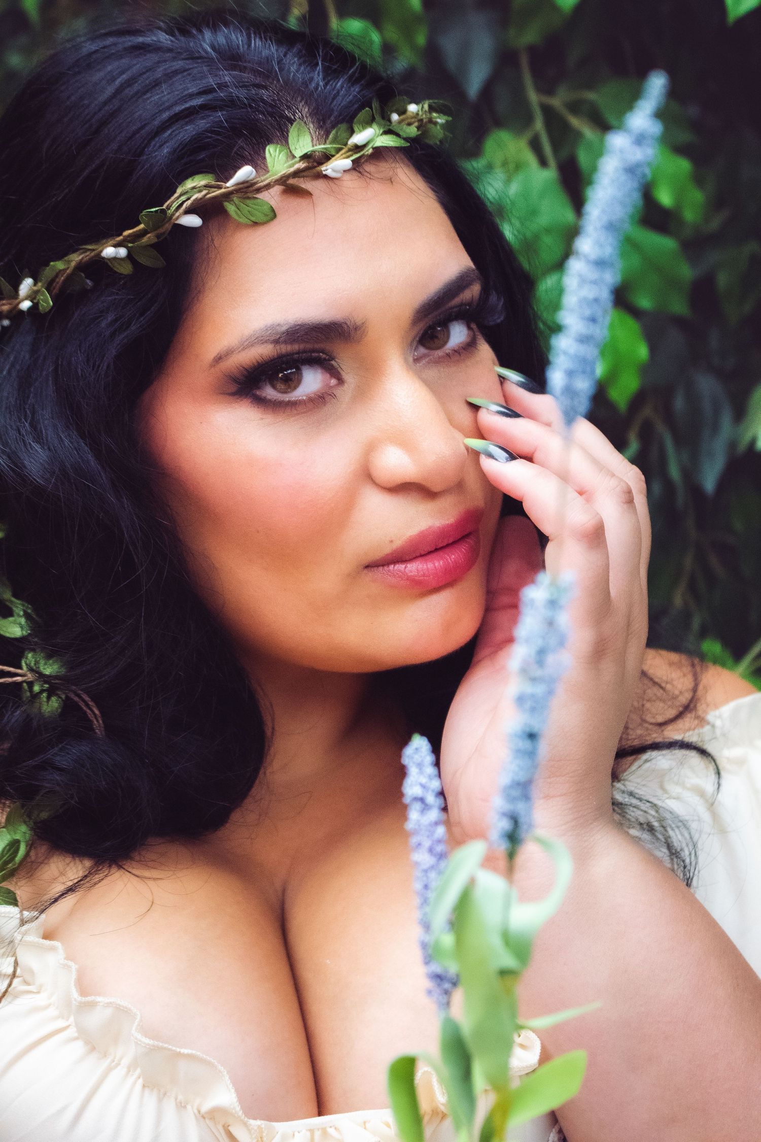 Dreamy portrait with ivy and greenery in romantic garden setting.