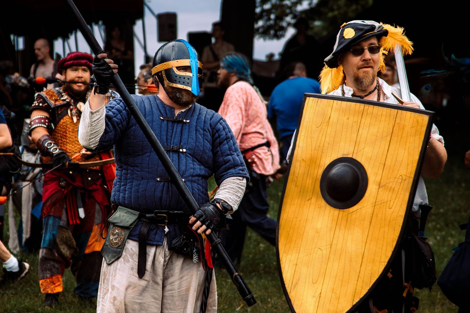 Musicians perform with traditional instruments at an outdoor folk music festival.