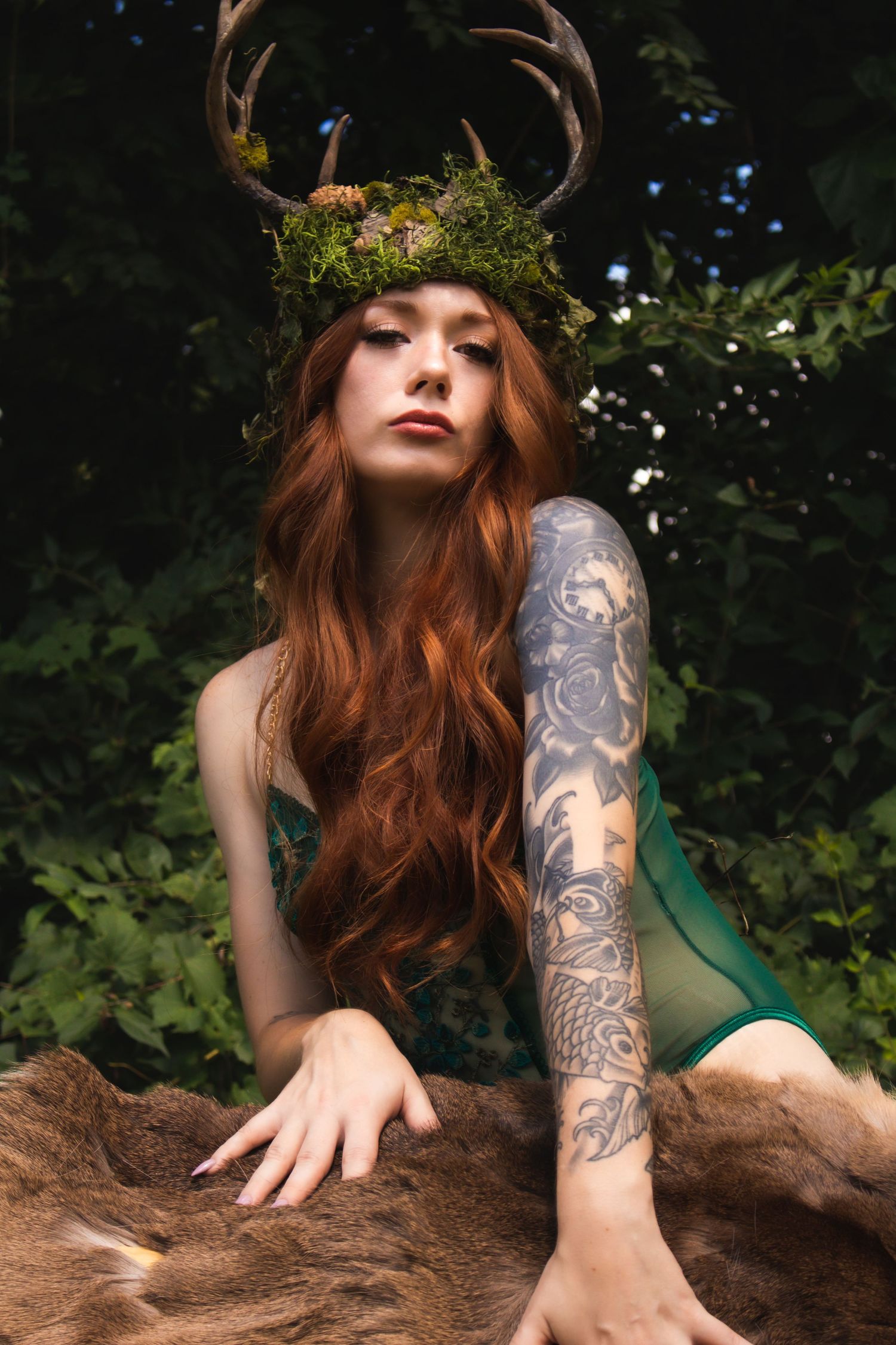 Artistic photo series showing a tattooed arm and flowing red hair against a natural forest backdrop.