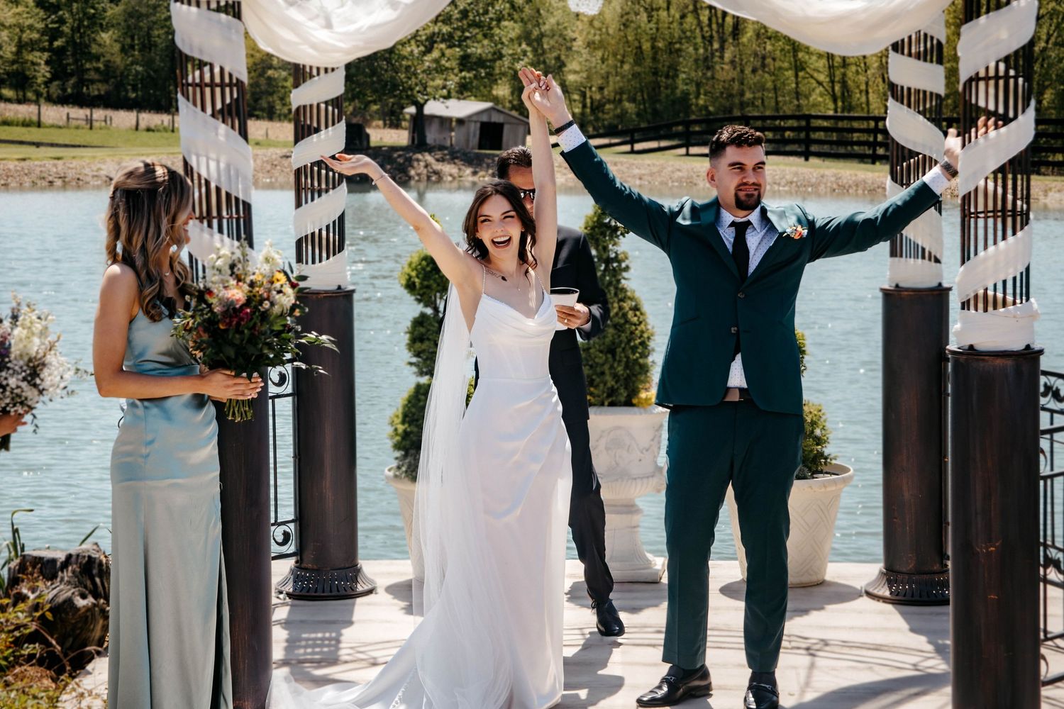 Wedding party celebrates on outdoor staircase with decorative white lanterns.