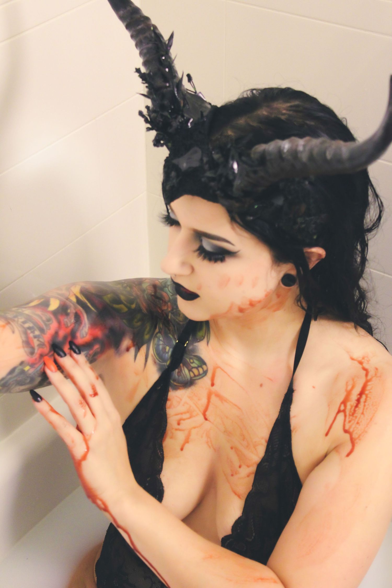 Artistic bathtub scene with dark gothic styling and dramatic poses.