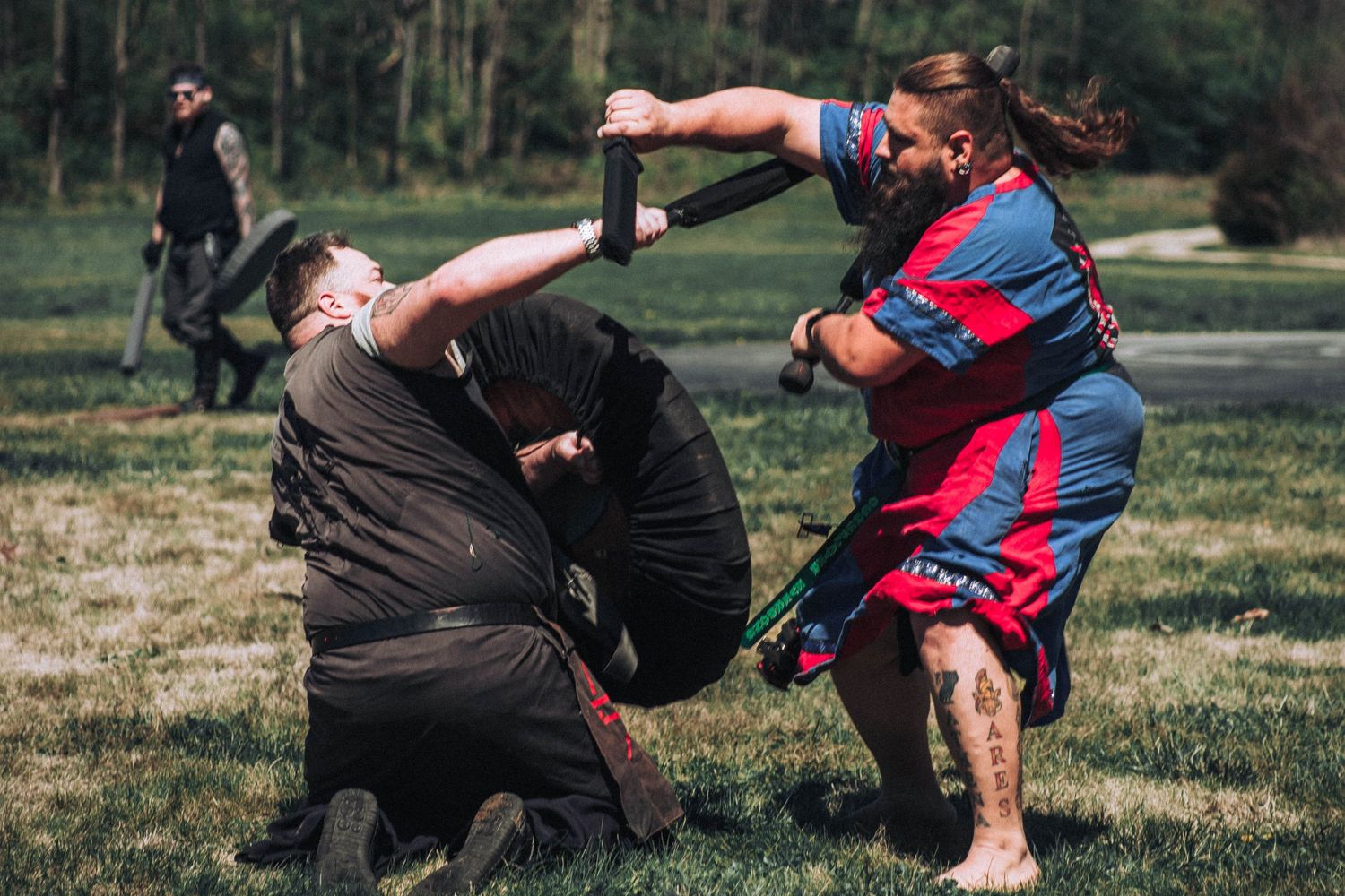 A sequence of photos showing two people practicing self-defense moves on a grassy field.