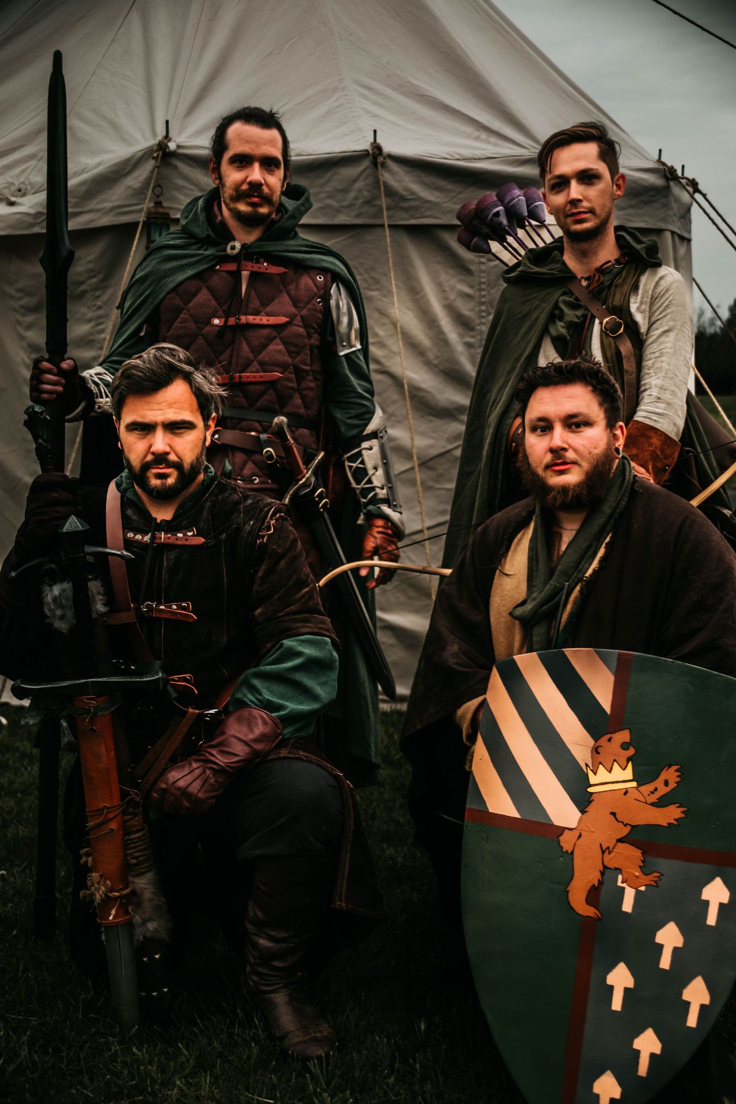 A collection of military-themed photos showing tactical gear, weapons, and shields with orange arrow markings against canvas tents.