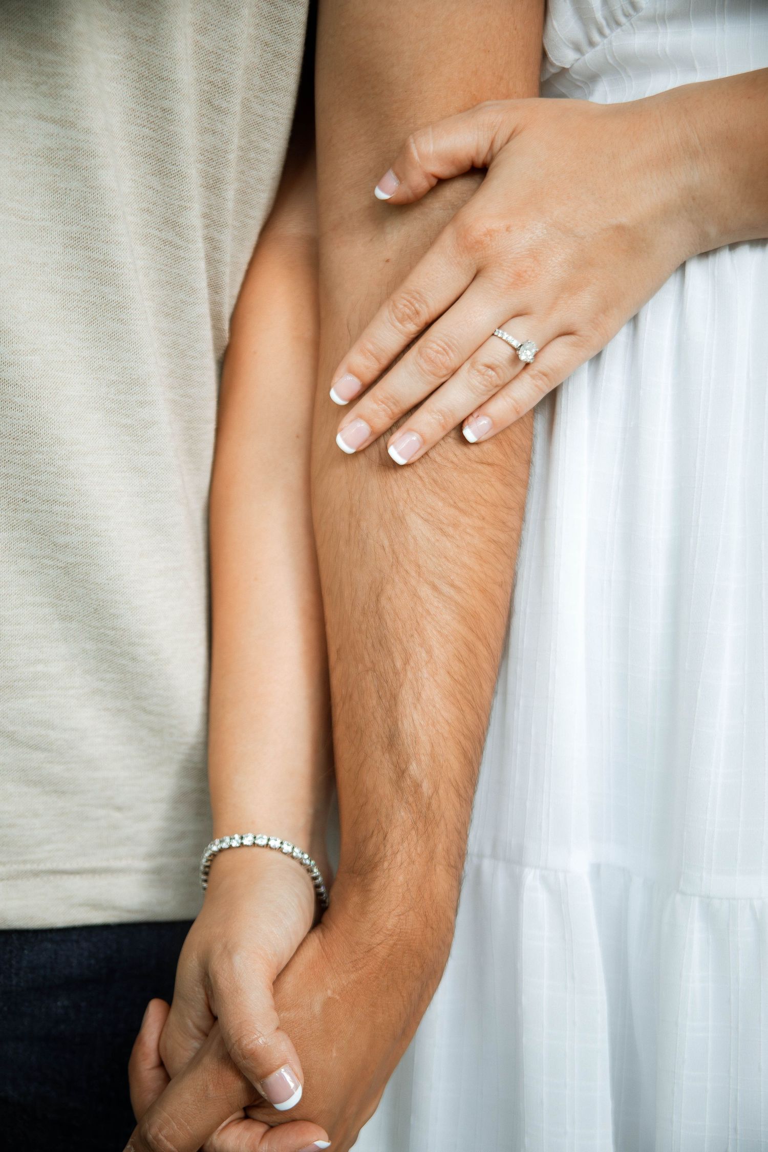 Close-up shots of hands with engagement ring showing tender moments of affection.