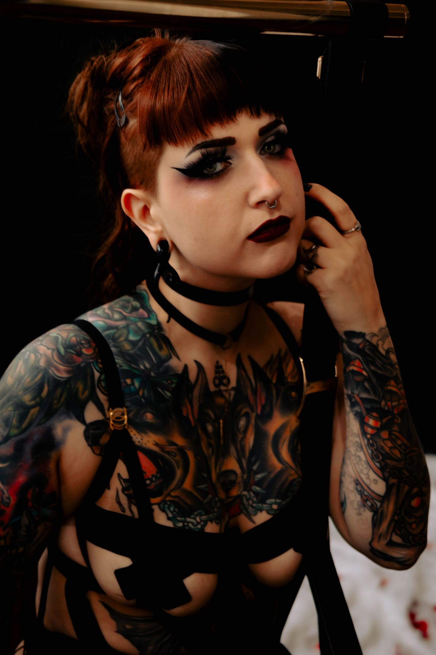 Dark gothic photo series featuring dramatic makeup, tattoos, and a black choker necklace in moody lighting.