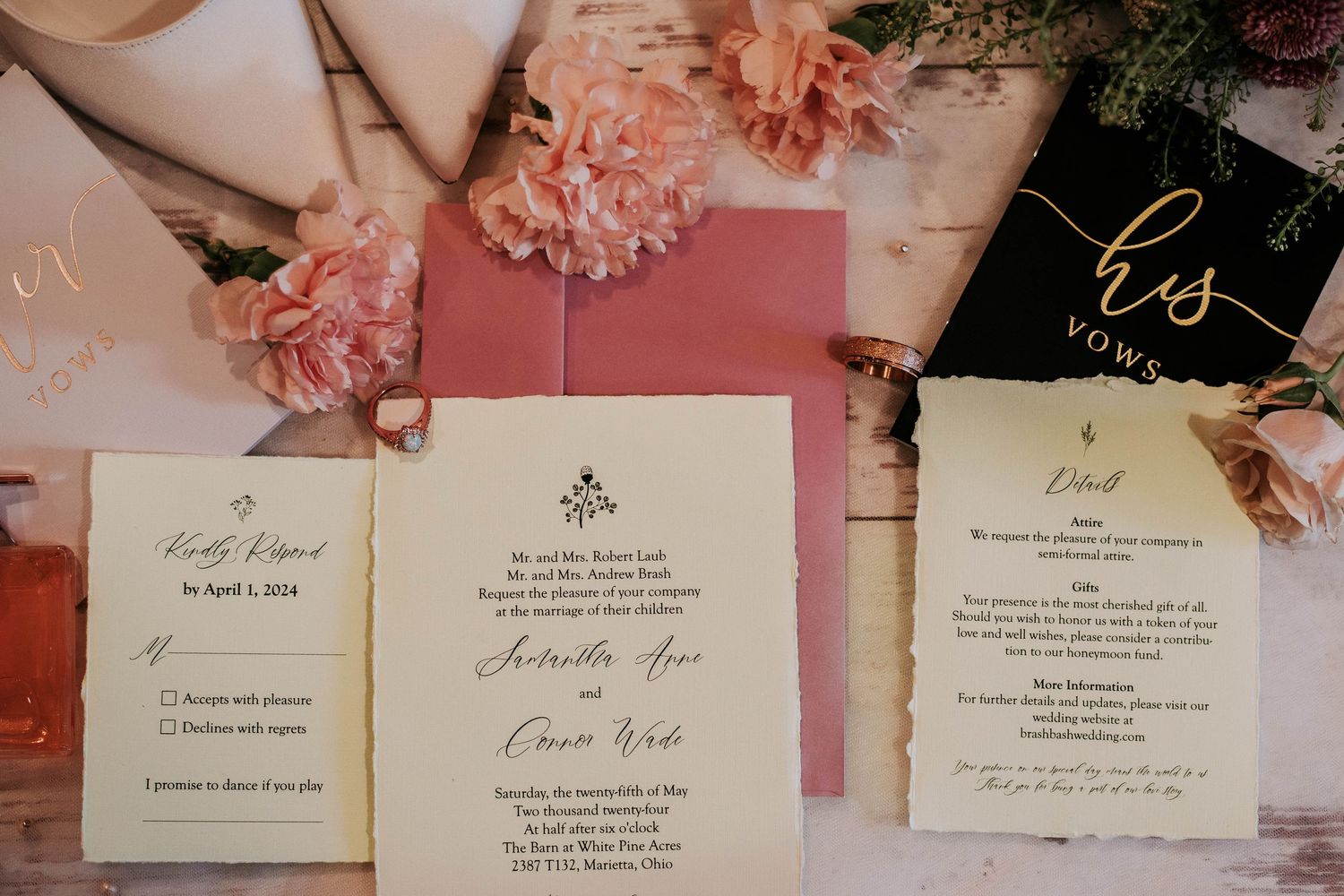 Wedding invitation suite with pink flowers and elegant calligraphy on white paper.