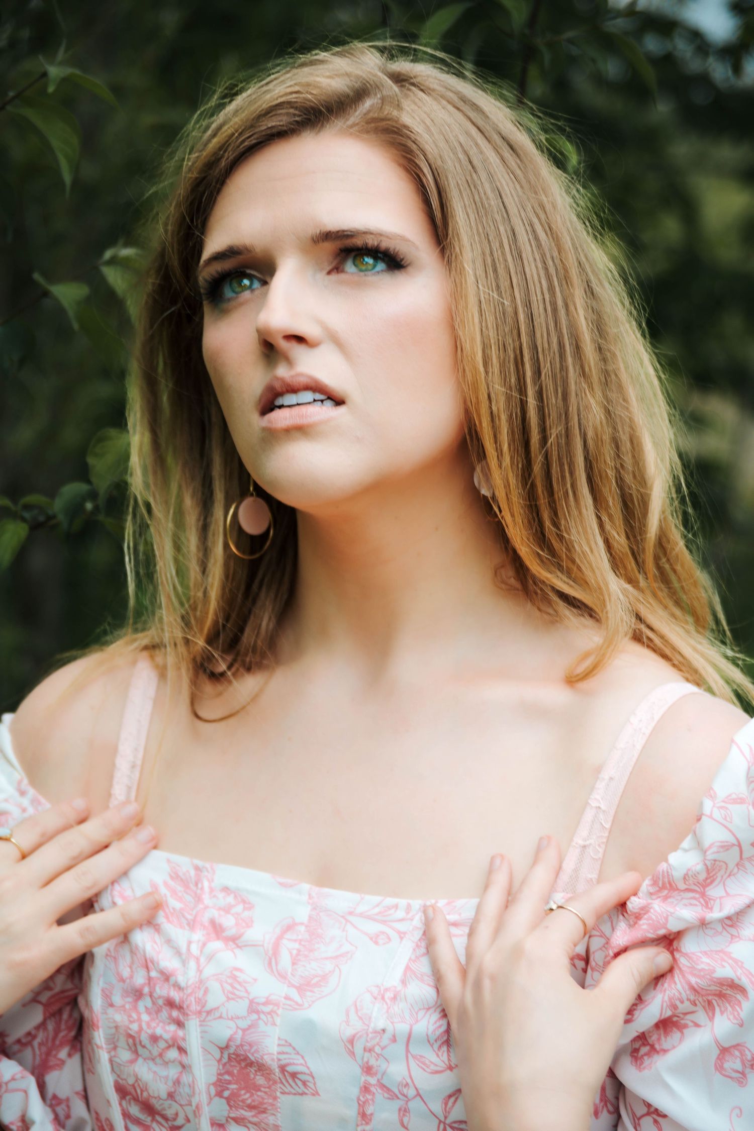Person in floral print dress photographed outdoors with natural lighting.