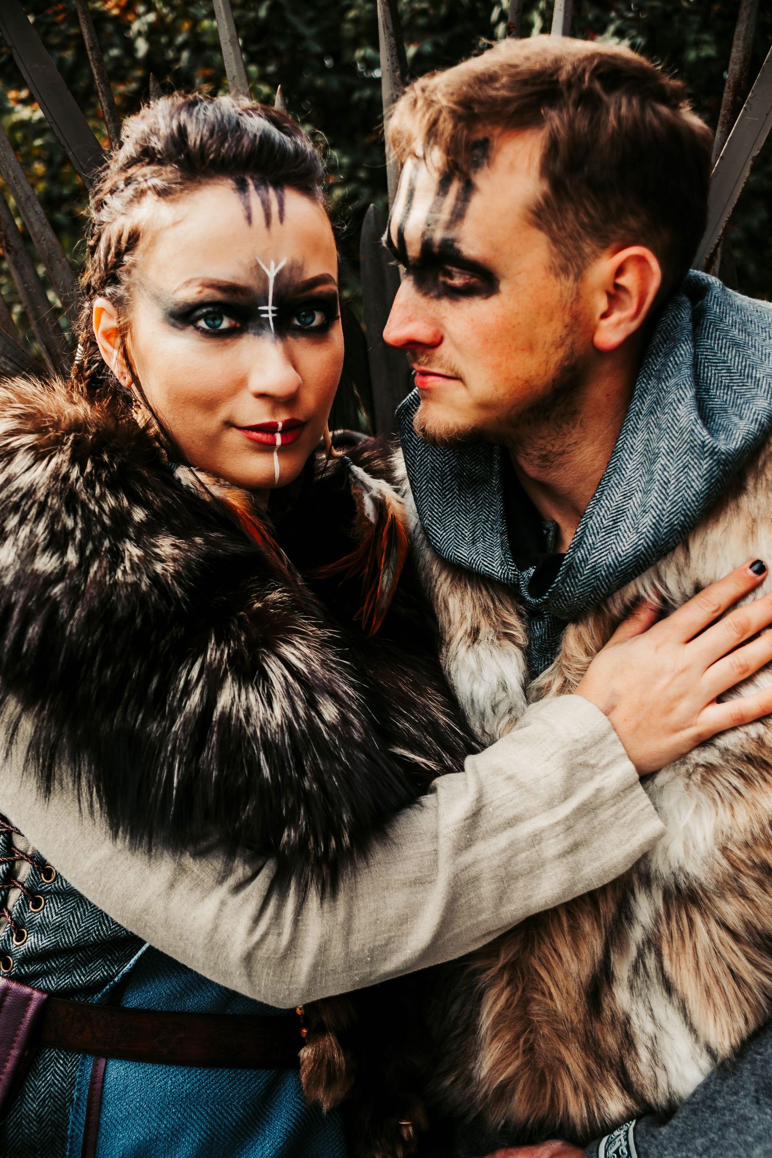 A dramatic close-up of two people in fur and winter wear during an intimate moment.