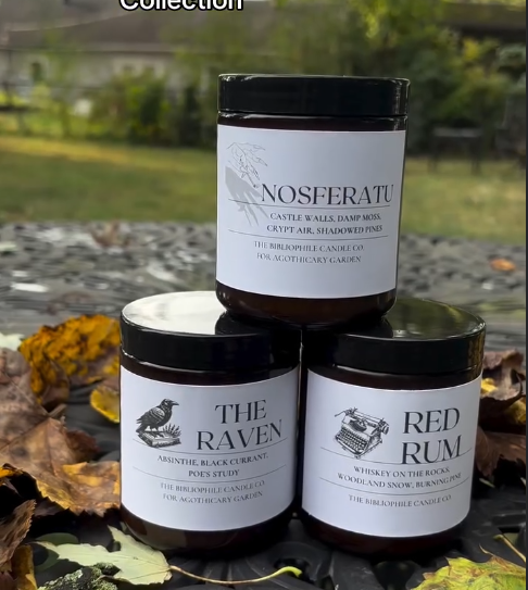 Collection of black glass jars with minimalist labels featuring bird designs arranged on natural outdoor surfaces.