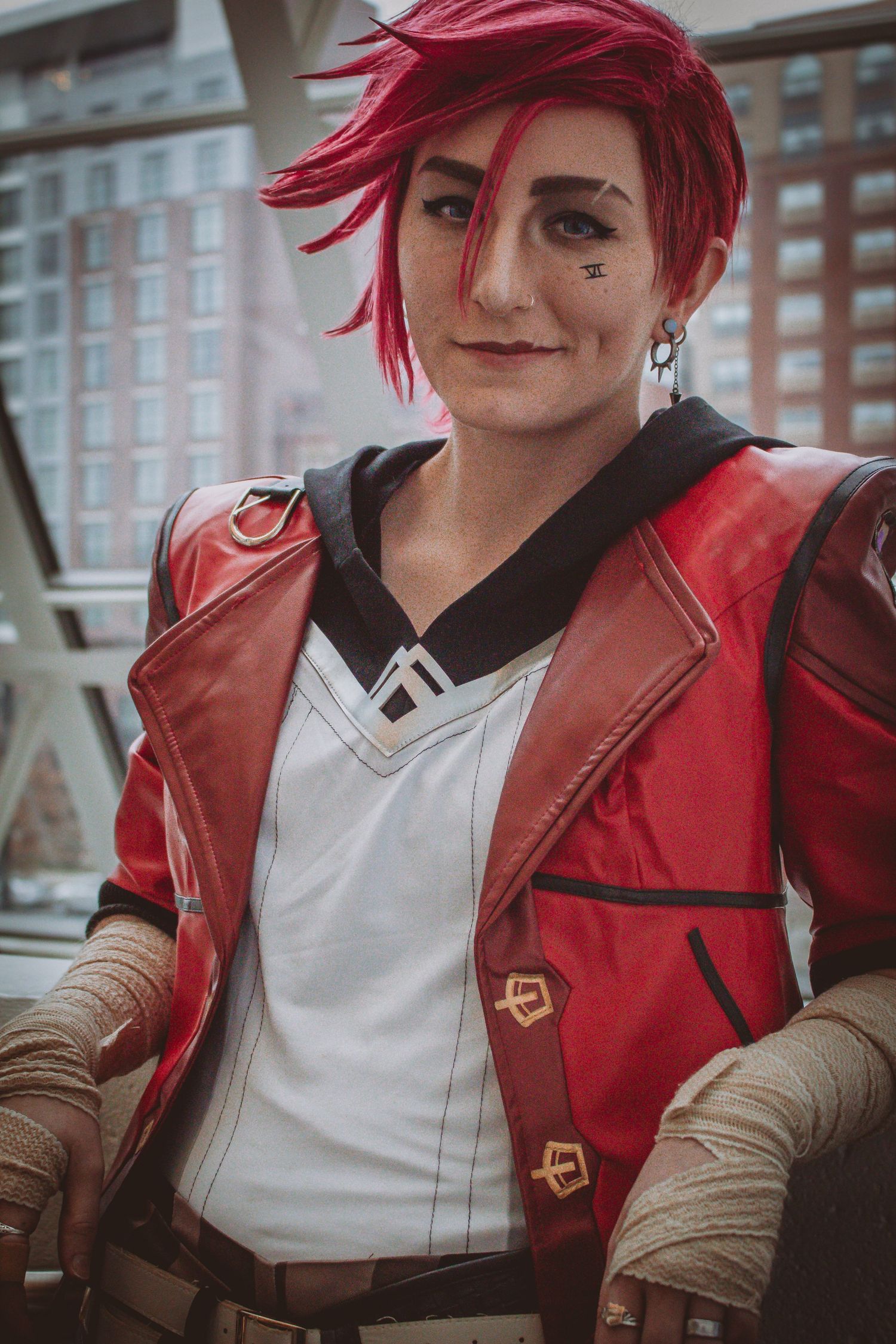 Cosplay character wearing red jacket and white shirt in urban setting.