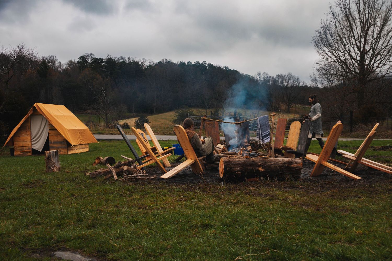 Storm damage debris scattered across a rural field with broken wooden beams and structural materials visible.