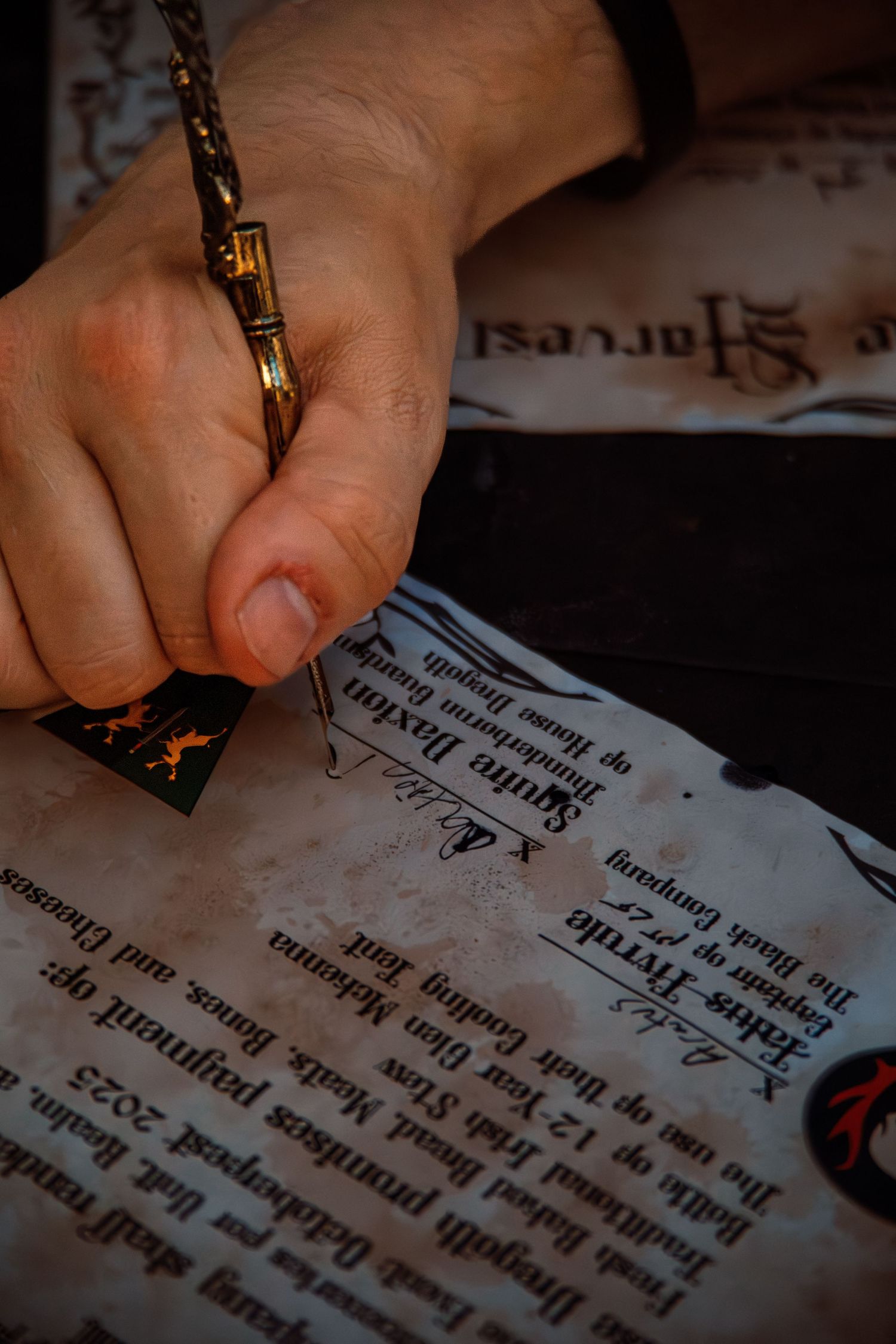 Hand writing or marking on aged parchment with decorative text.
