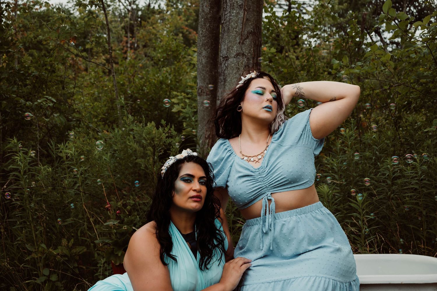 Woman in a light blue dress poses outdoors against a natural green backdrop in a series of lifestyle photos.