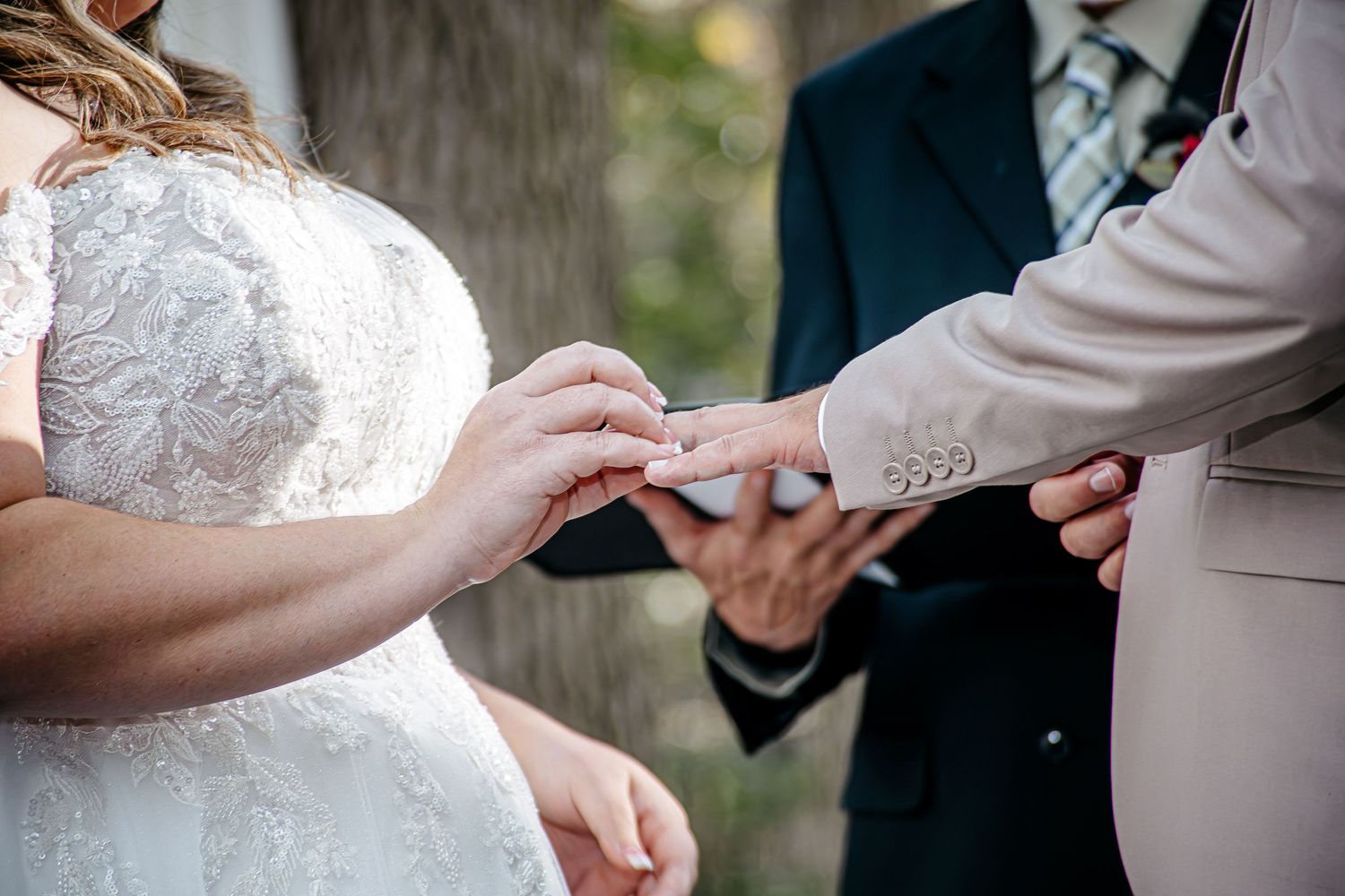 Close-up shots of wedding ceremony details including rings and hands.