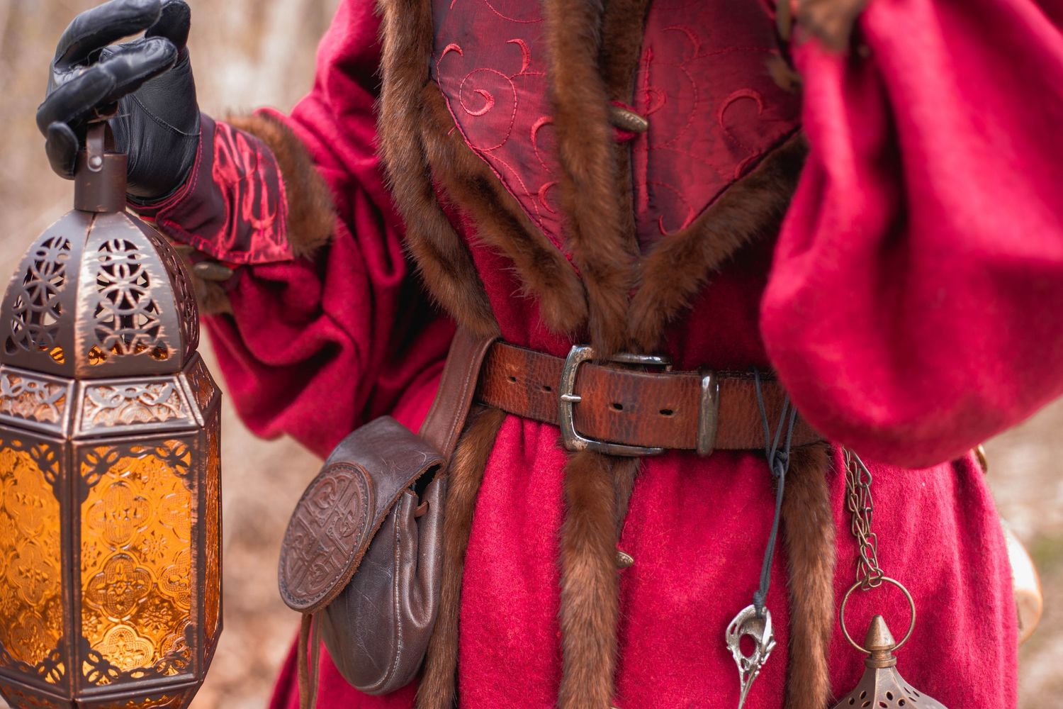 Decorative lanterns and red fabric create a romantic medieval fantasy atmosphere with warm glowing candlelight.