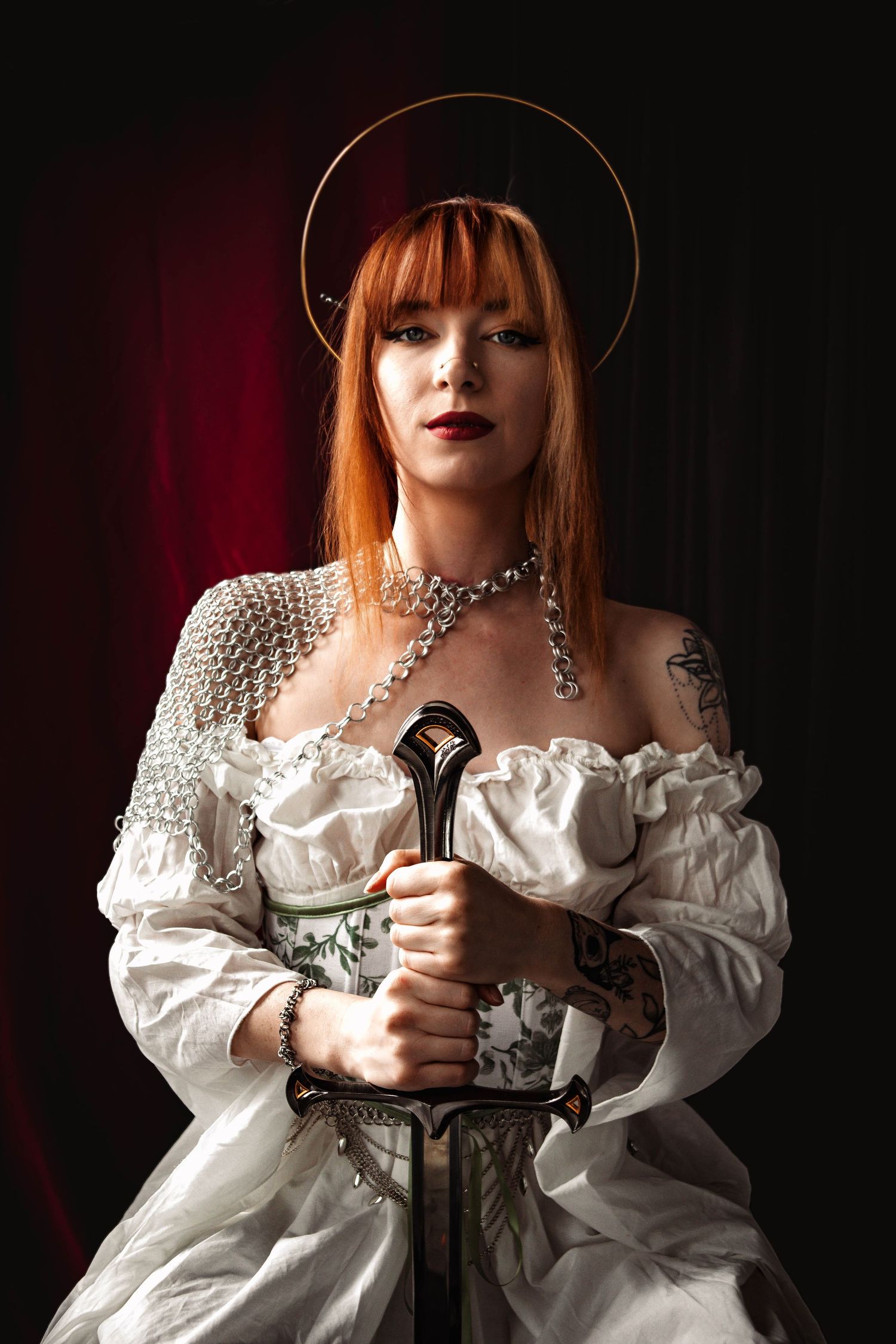 A dramatic portrait series showing a figure in a white ruffled dress holding a medieval sword against a dark background.