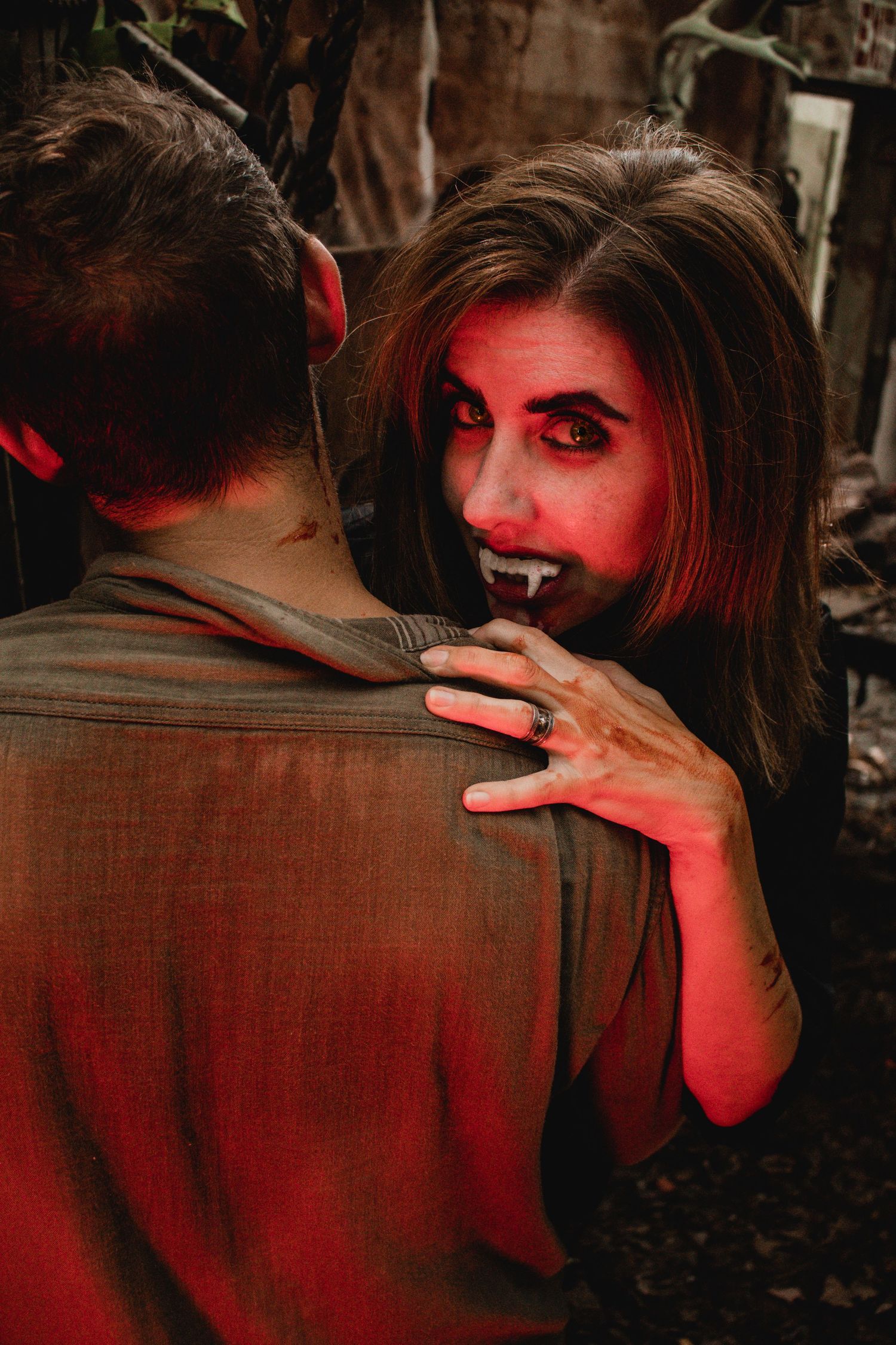 Two figures in red lighting share an intimate moment in a dramatic sequence of connected photos.