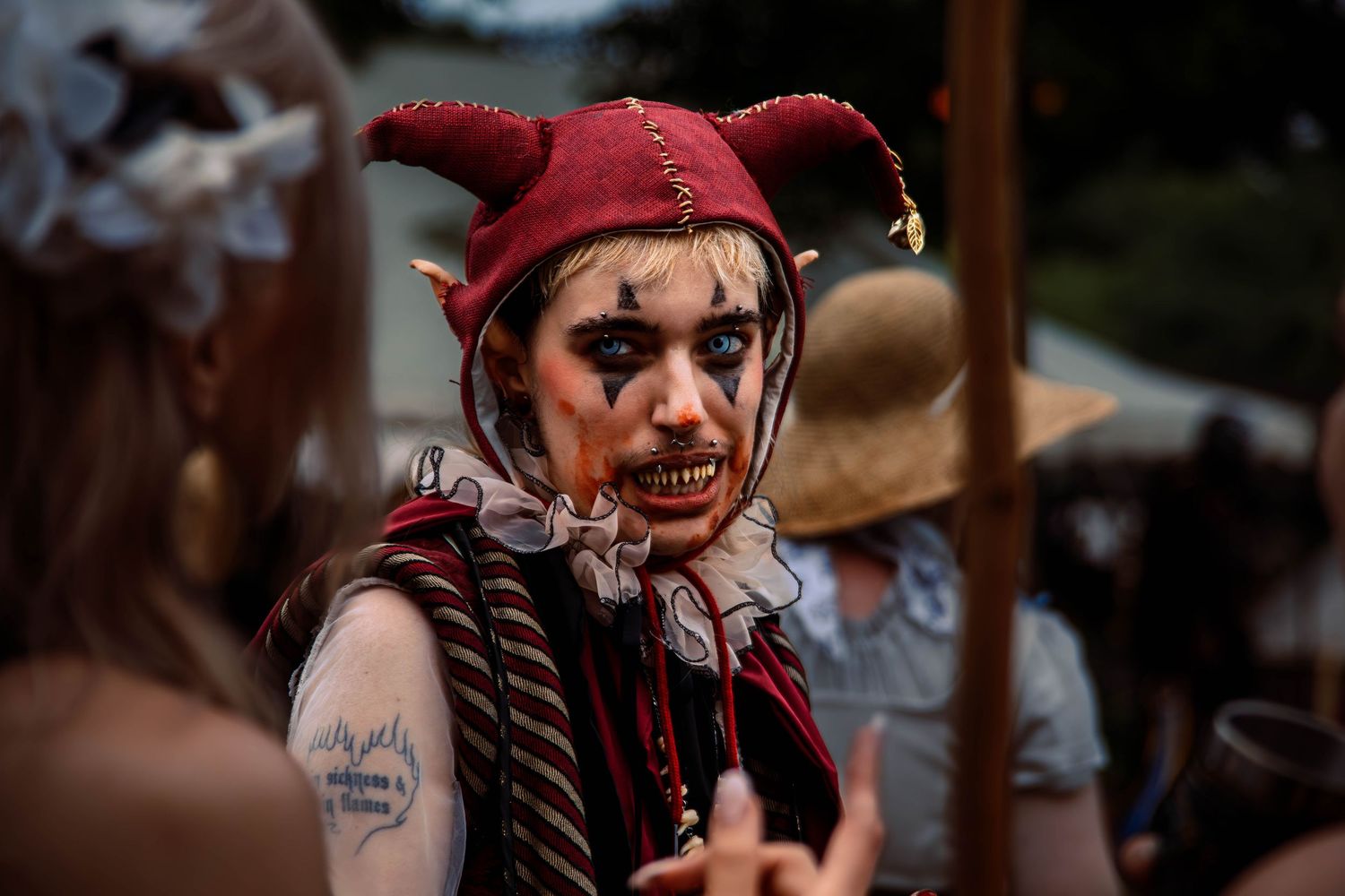 Participants in medieval costumes engaged in outdoor combat reenactment.