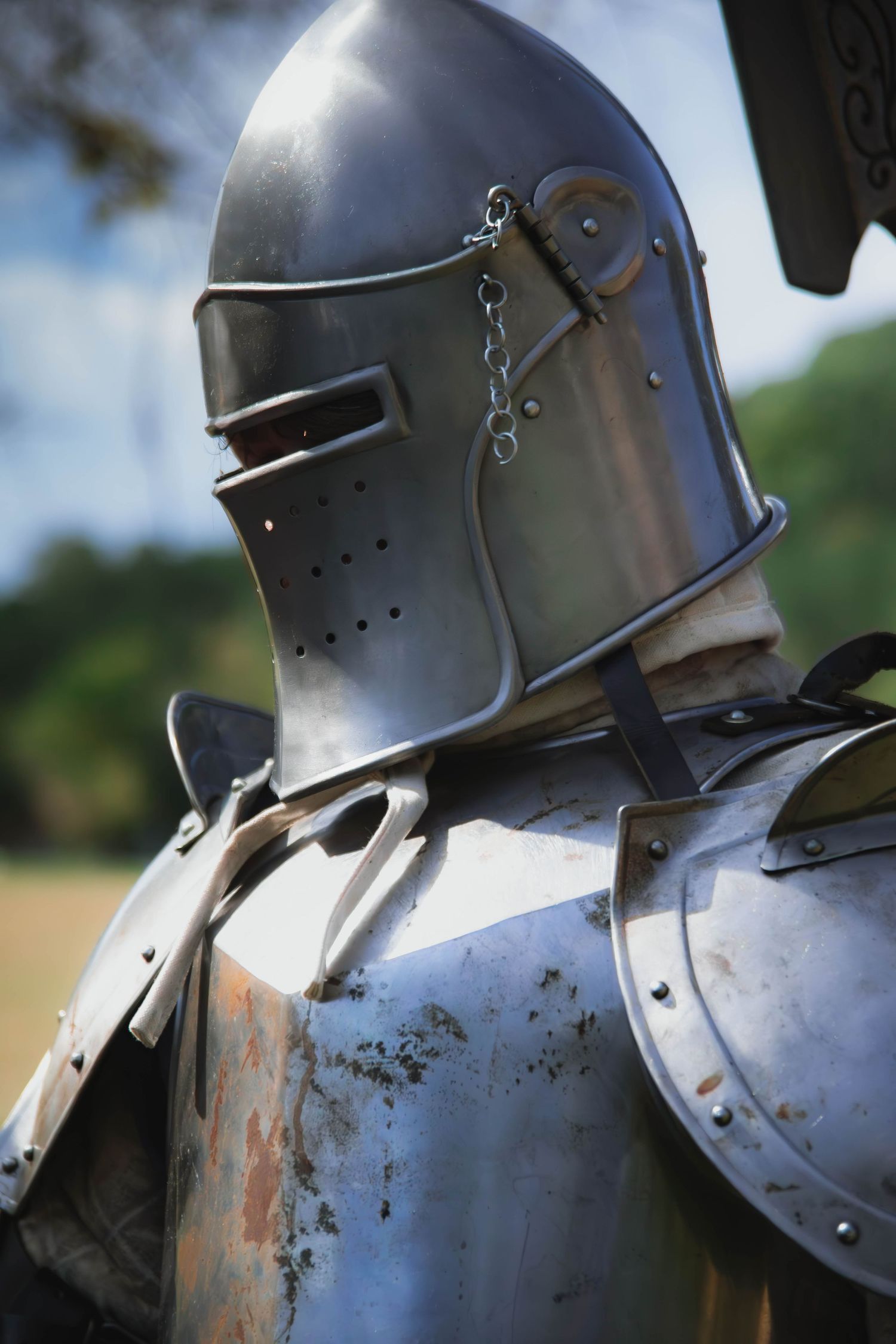 Close-up profile view of medieval knight's helmet with visor in sunlight.