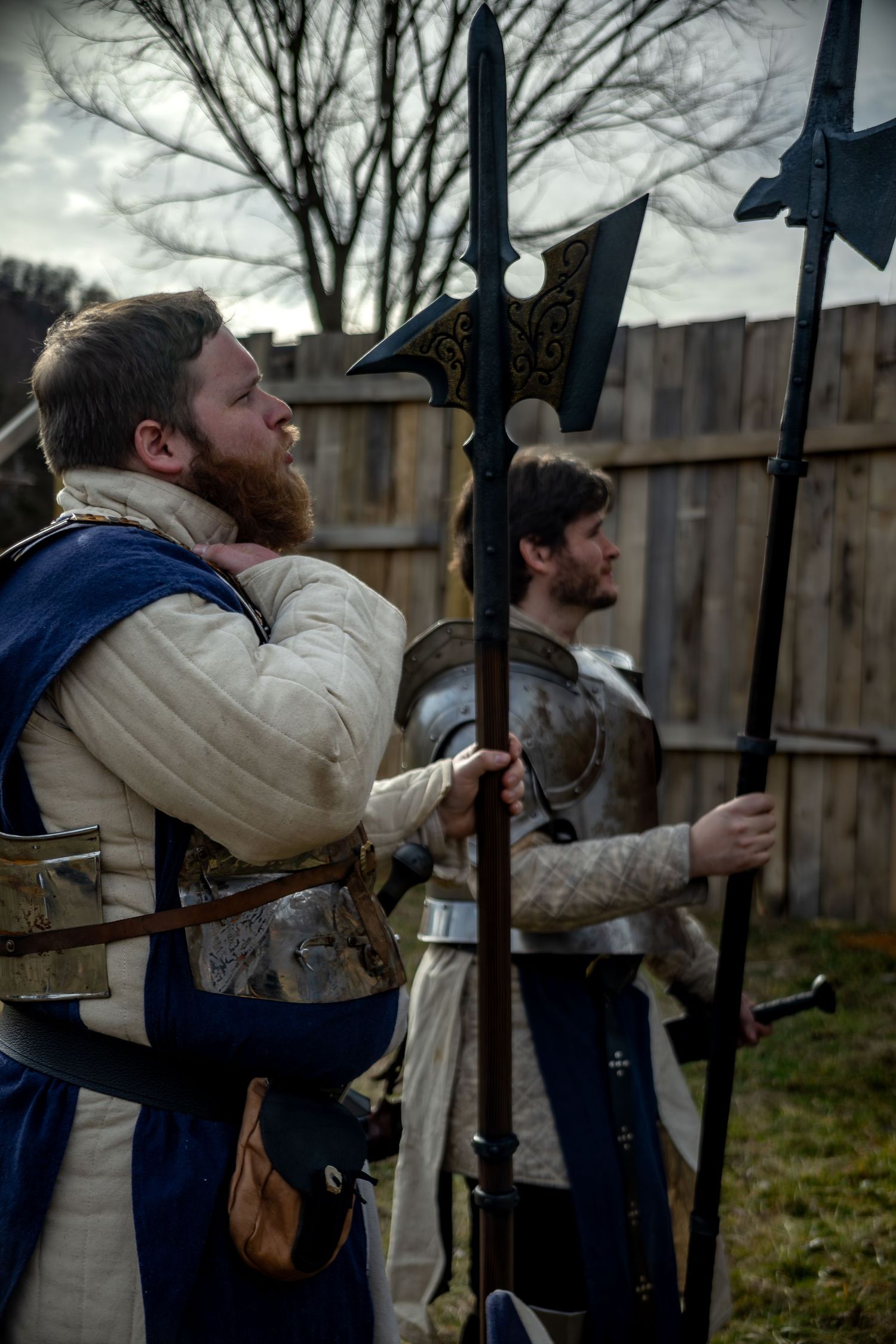 A sequence of photos showing a historical reenactor demonstrating the loading and firing of a musket against an iron fence.