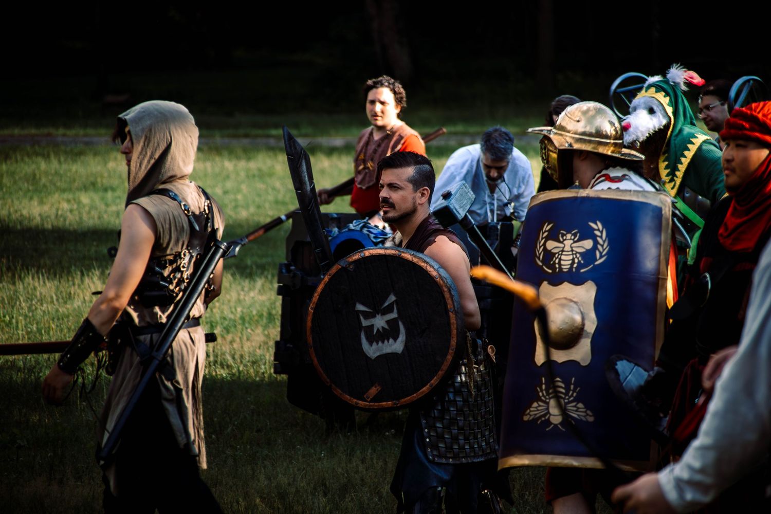 Medieval reenactors in period costumes engage in sword combat during a historical demonstration event.