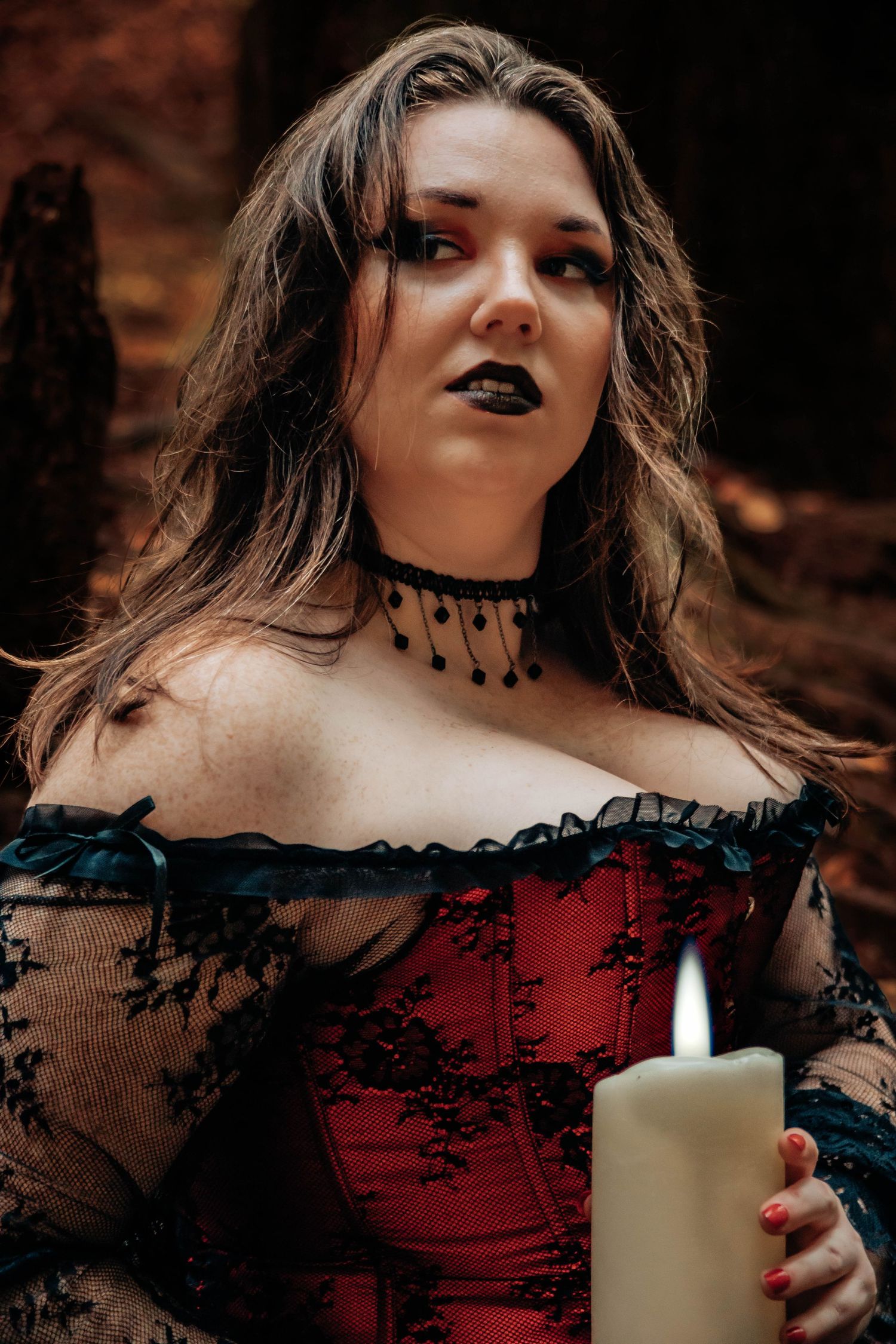 Gothic portrait series featuring red corset, black lace, and dramatic candle lighting.