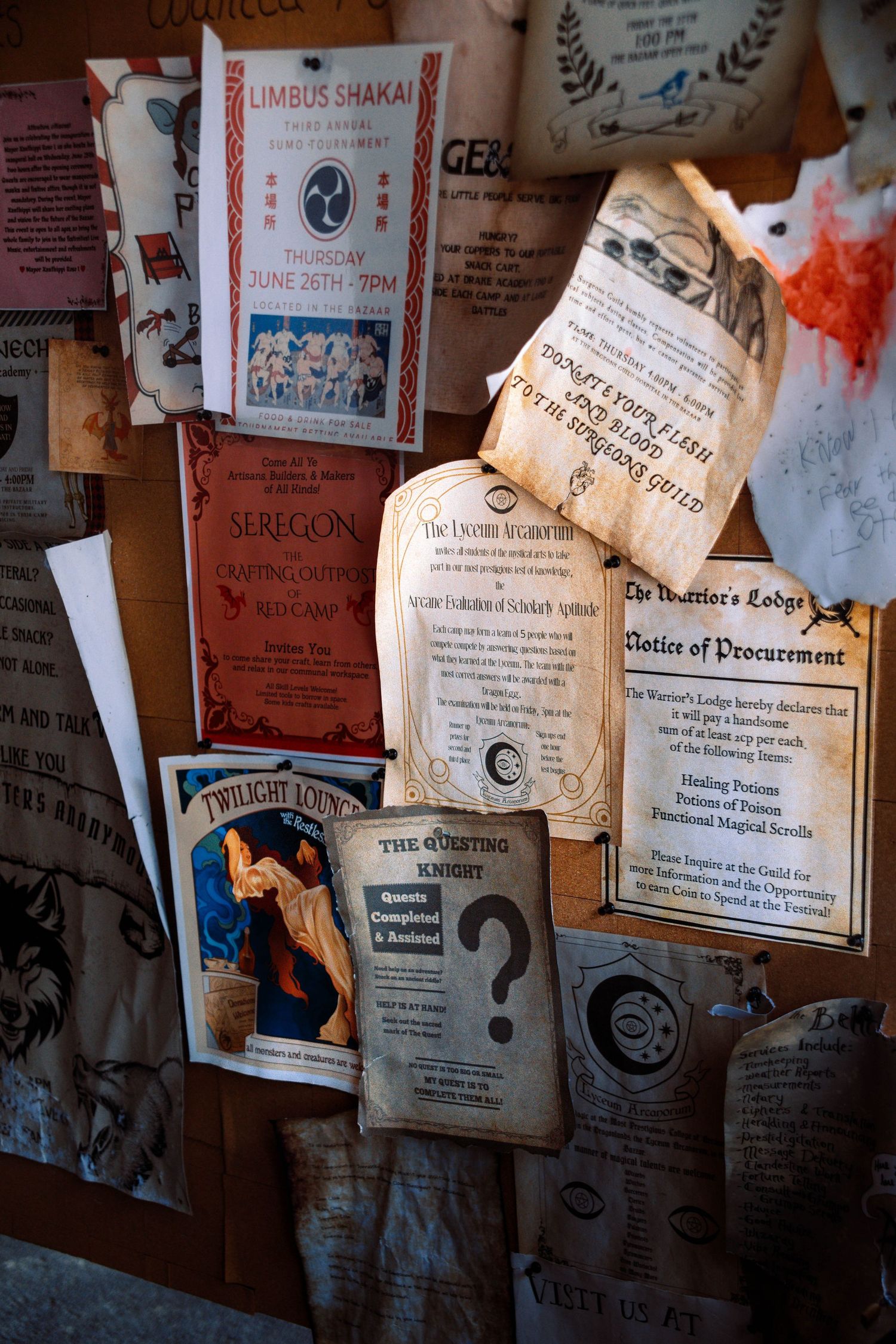 A collection of old certificates, diplomas and documents pinned to a bulletin board in warm lighting.