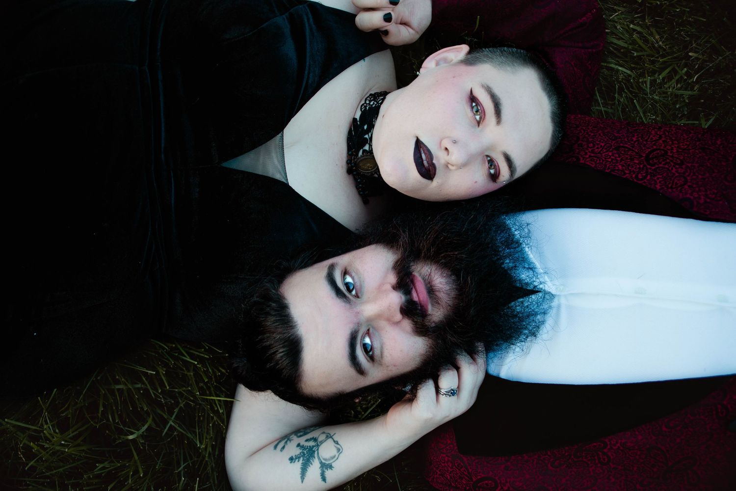 Dramatic moody photoshoot series features dark contrasting lighting and dark makeup against pale skin tones.
