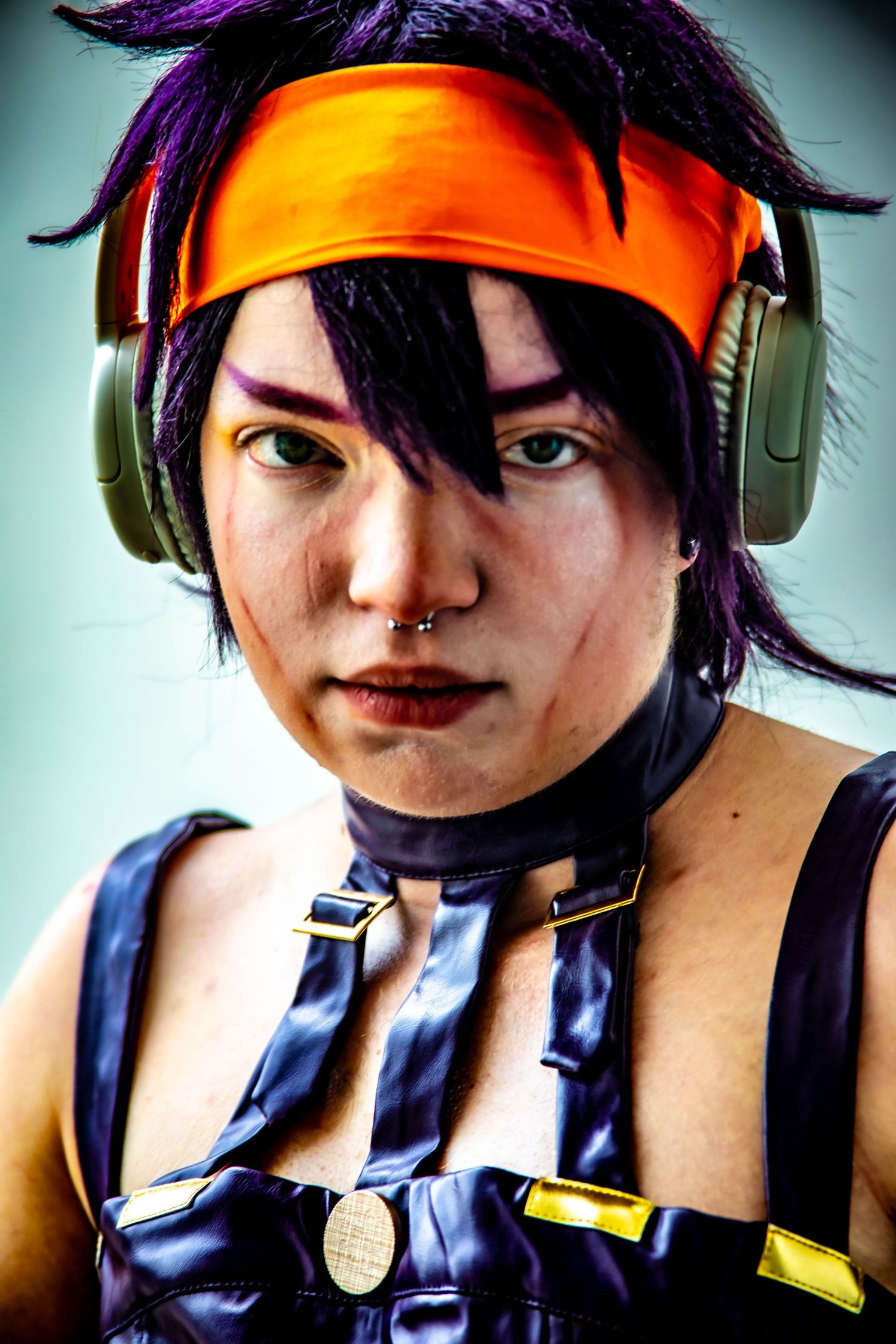 Edgy cyberpunk style portraits with purple hair, orange headband and gaming headphones.