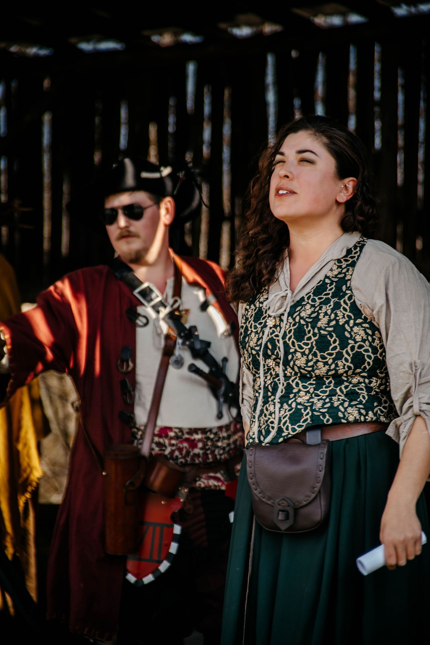 A sequence of candid moments showing people in vintage-inspired outfits dancing and socializing at a forest gathering.