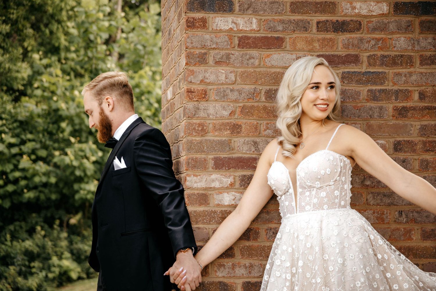 A romantic wedding sequence shows a couple in formal attire dancing and twirling against a rustic brick wall backdrop.