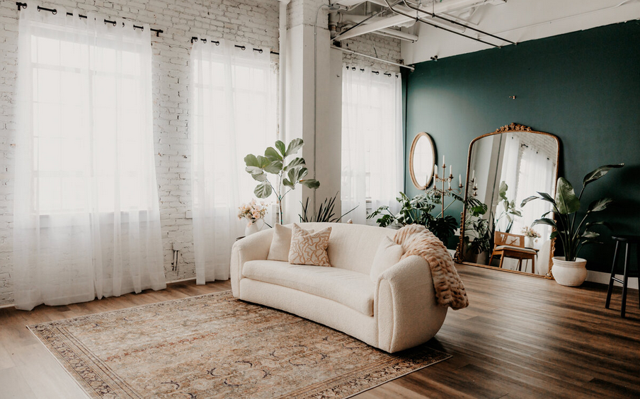 A series of minimalist interior design photos showing empty rooms with white walls and natural light.