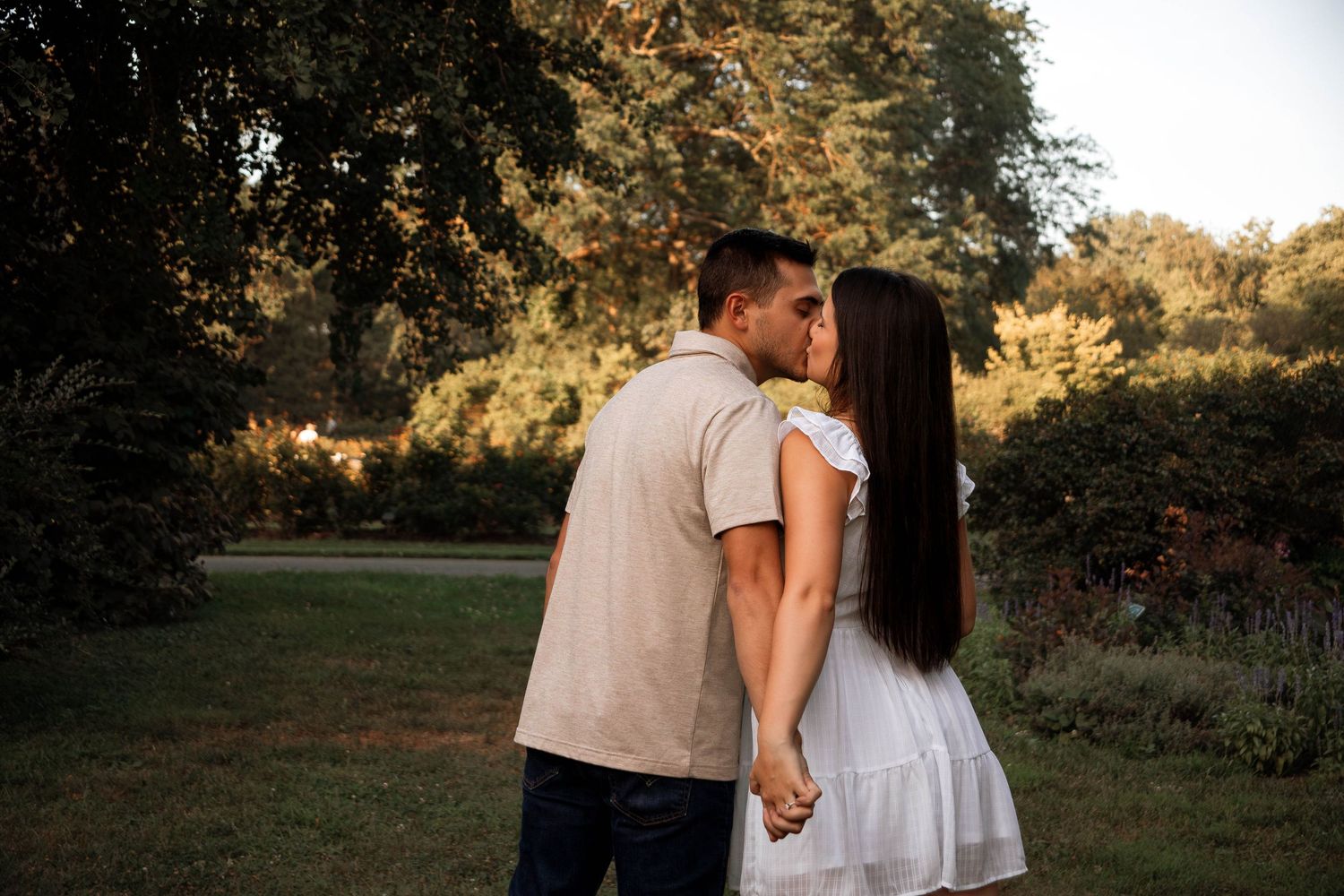 Romantic couple shares tender moment in autumn forest setting.