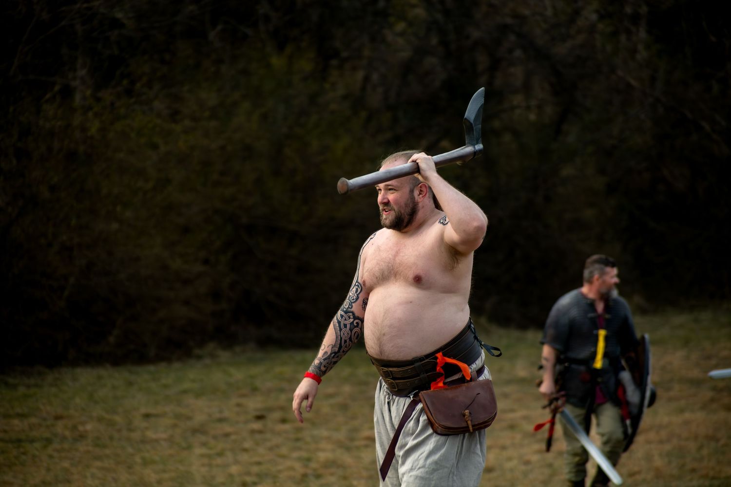 A shirtless person performs a backflip sequence on grass, captured in a multi-frame action sequence.