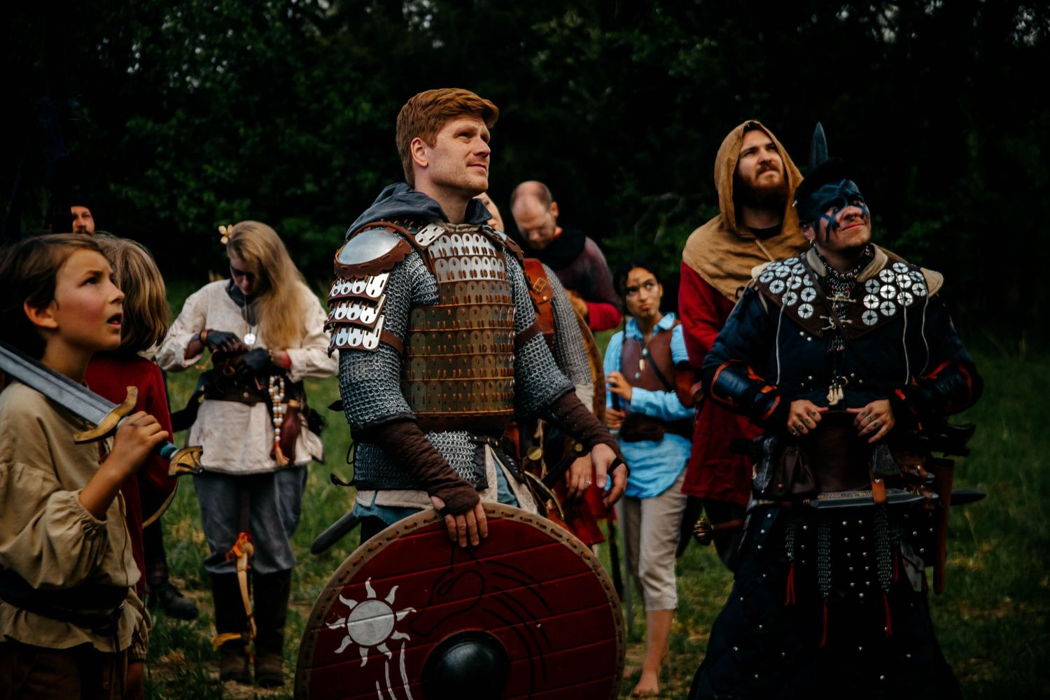 A crowd gathers outdoors for what appears to be a medieval or fantasy themed event.