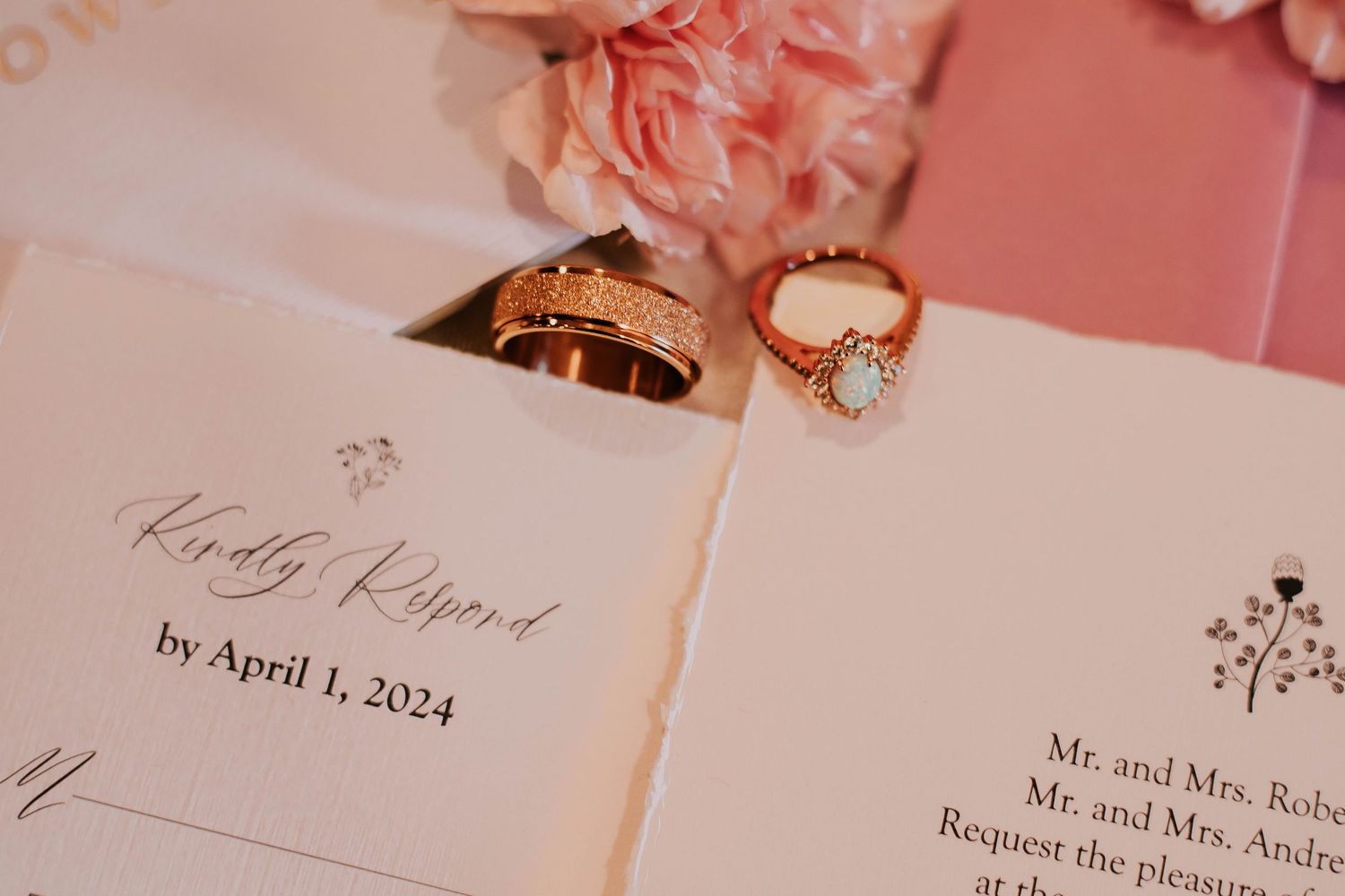 Wedding rings displayed on an invitation with April 2024 date visible.