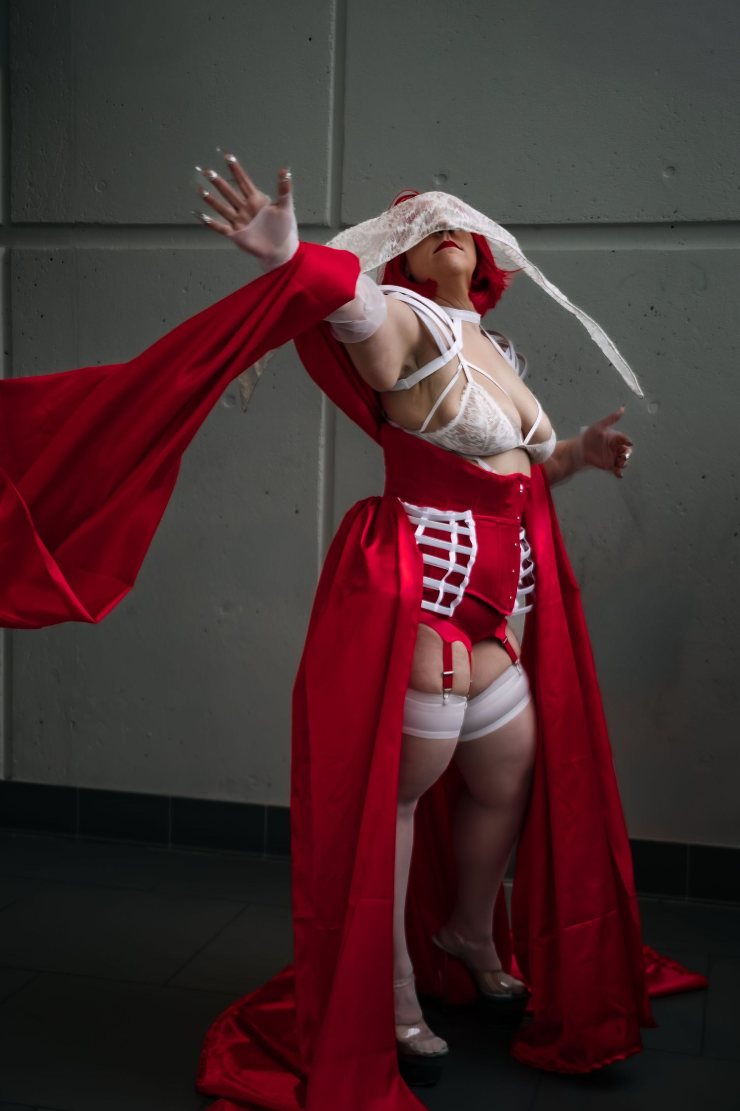 A sequence of five images showing someone in a red robe and white undergarments performing a dynamic dance movement.