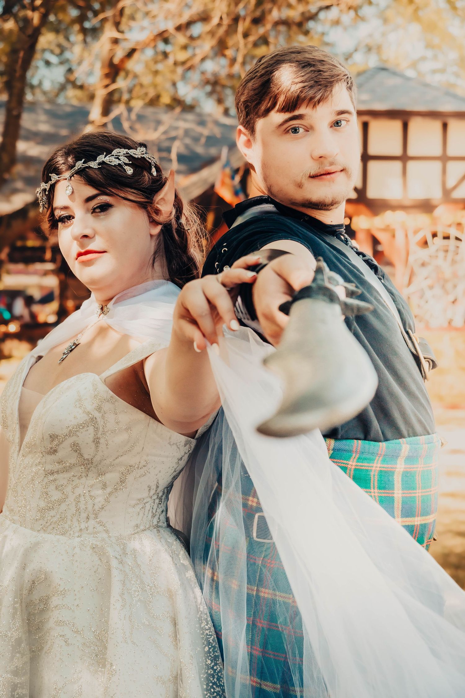 Wedding party poses in warm autumn light wearing vintage-inspired attire.