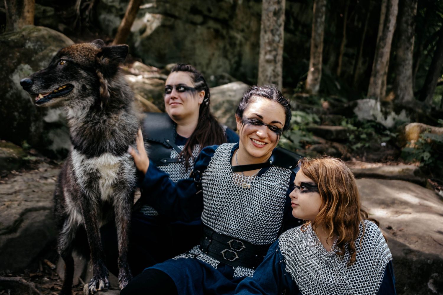 Group enjoying a casual moment outdoors in a wooded setting.