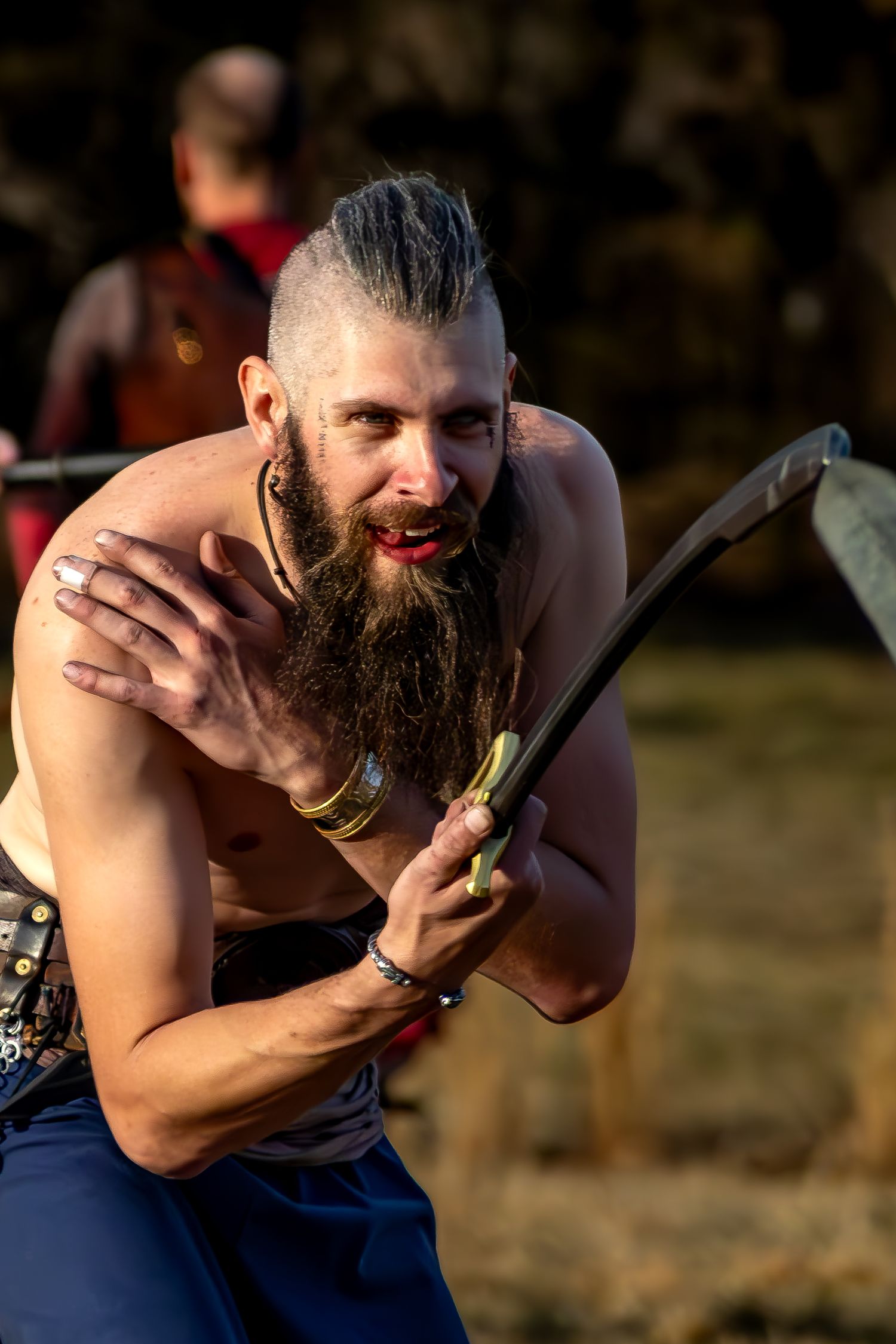 A bearded man in a blue tank top takes bites from a celery stalk in a progressive series of photos.