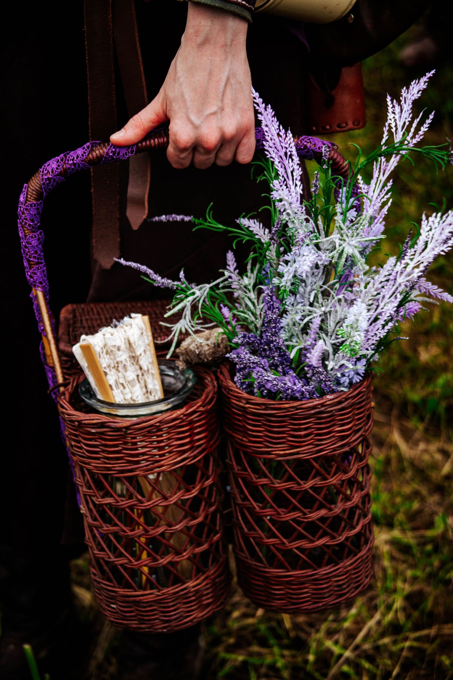 A sequence showing purple and white flowers being arranged in dark wicker baskets against a natural outdoor background.
