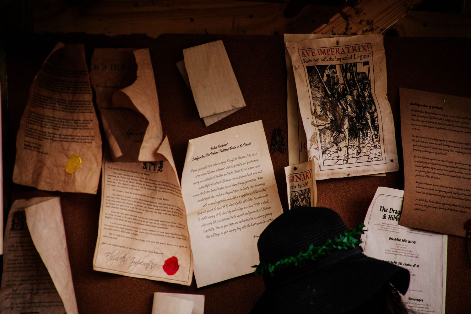 Old documents and papers with red wax seal scattered on dark wooden surface in vintage style.