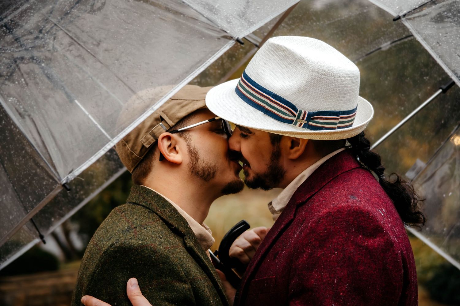 A romantic couple in western attire sharing intimate moments under a rustic wooden structure.