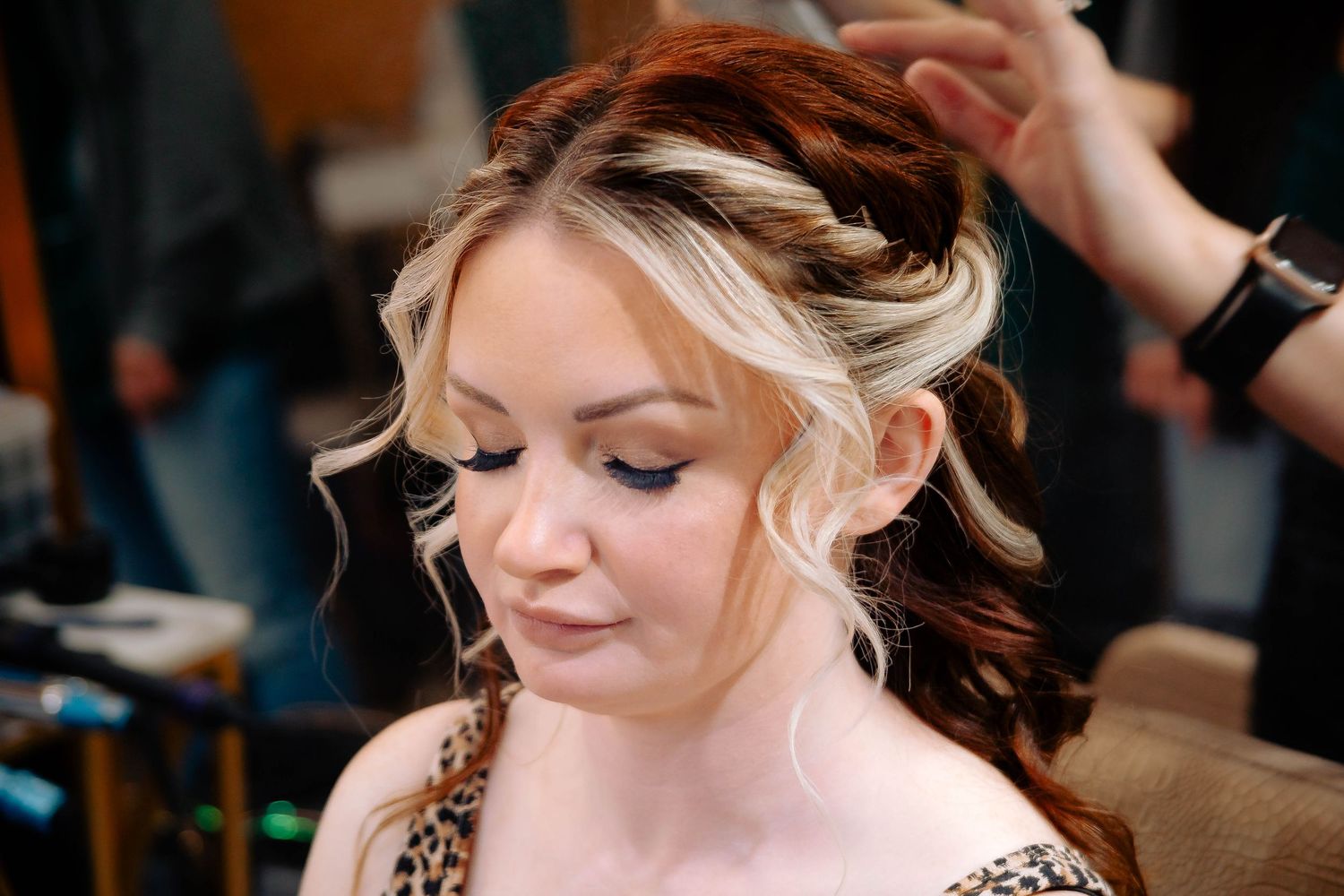 Close-up of bridal hairstyling with blonde highlights and romantic curls.
