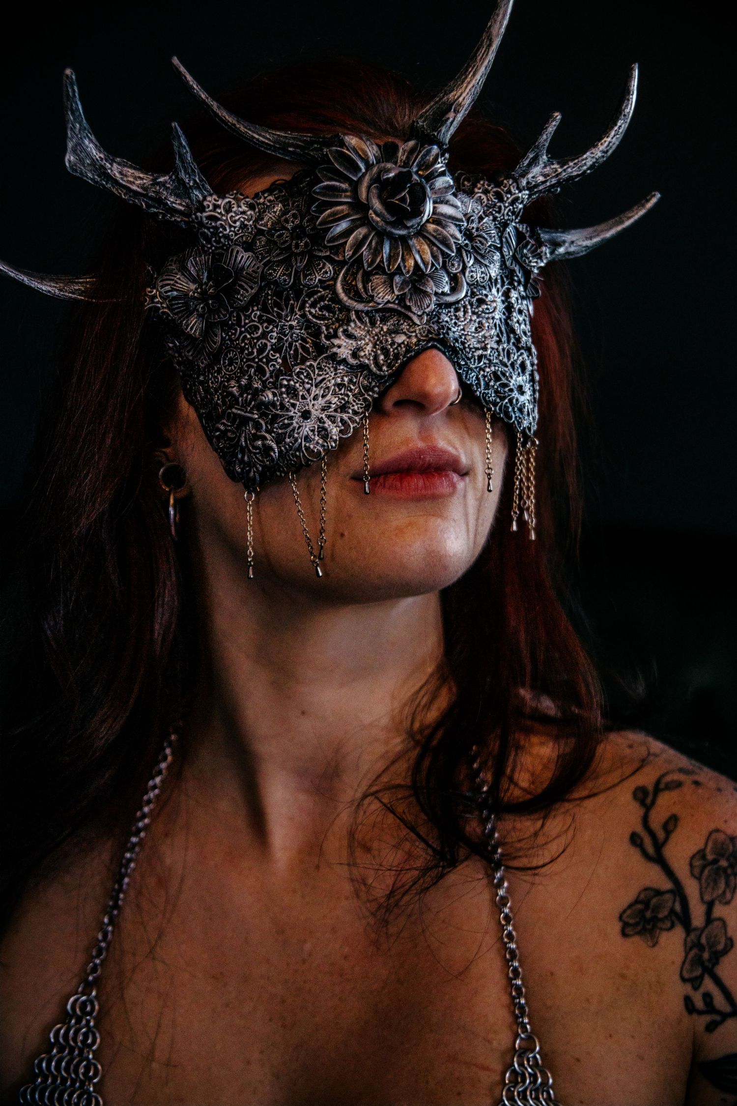 Close-up shots of an ornate silver masquerade mask with gothic details.
